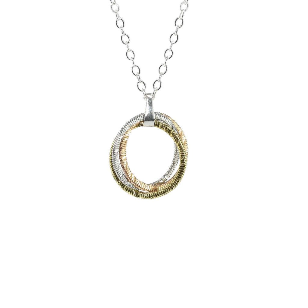 round pendant made from three kinds of guitar string on a silver chain and white background