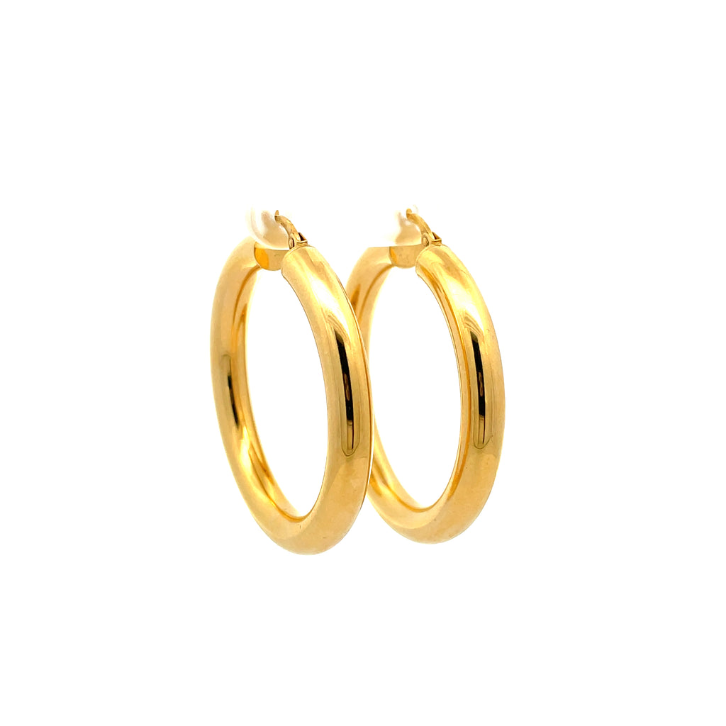 thick gold hoops on white background