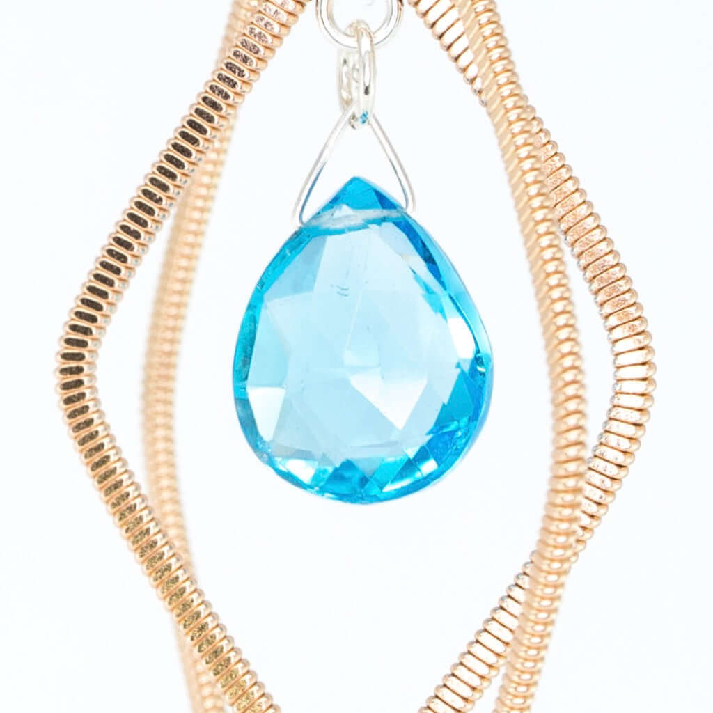Acoustic guitar string diamond shaped earrings with Swiss Blue topaz suspended in the centre