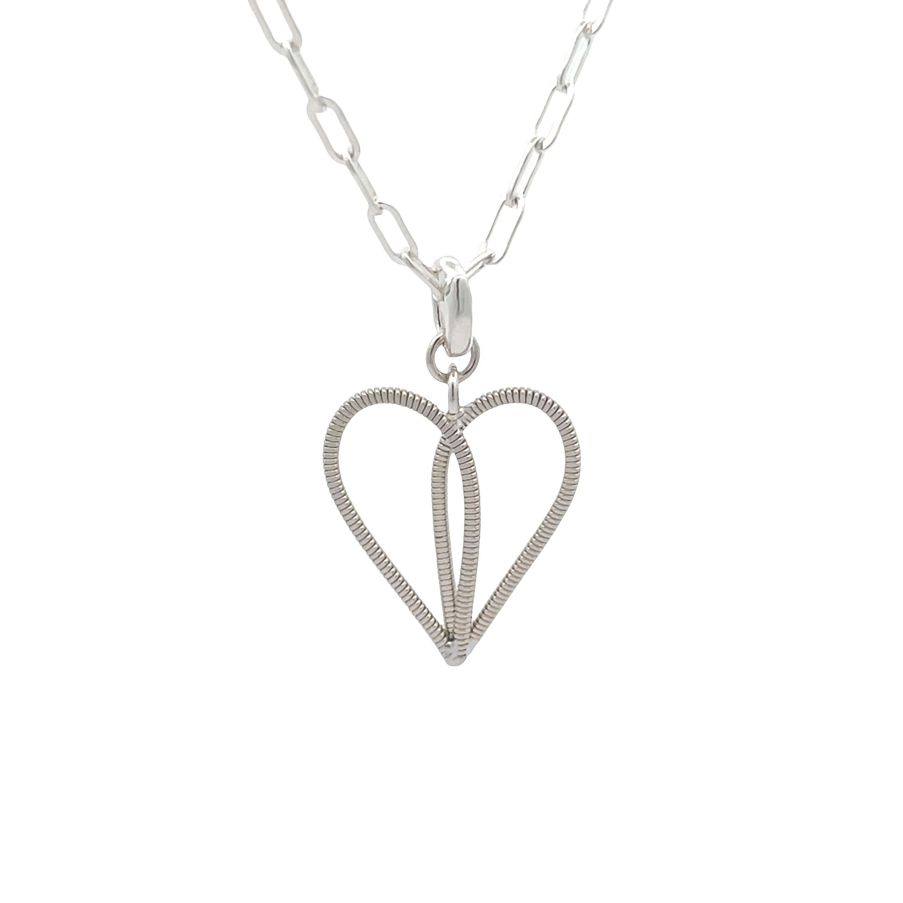 Silver guitar string heart with oval link silver chain on a white background