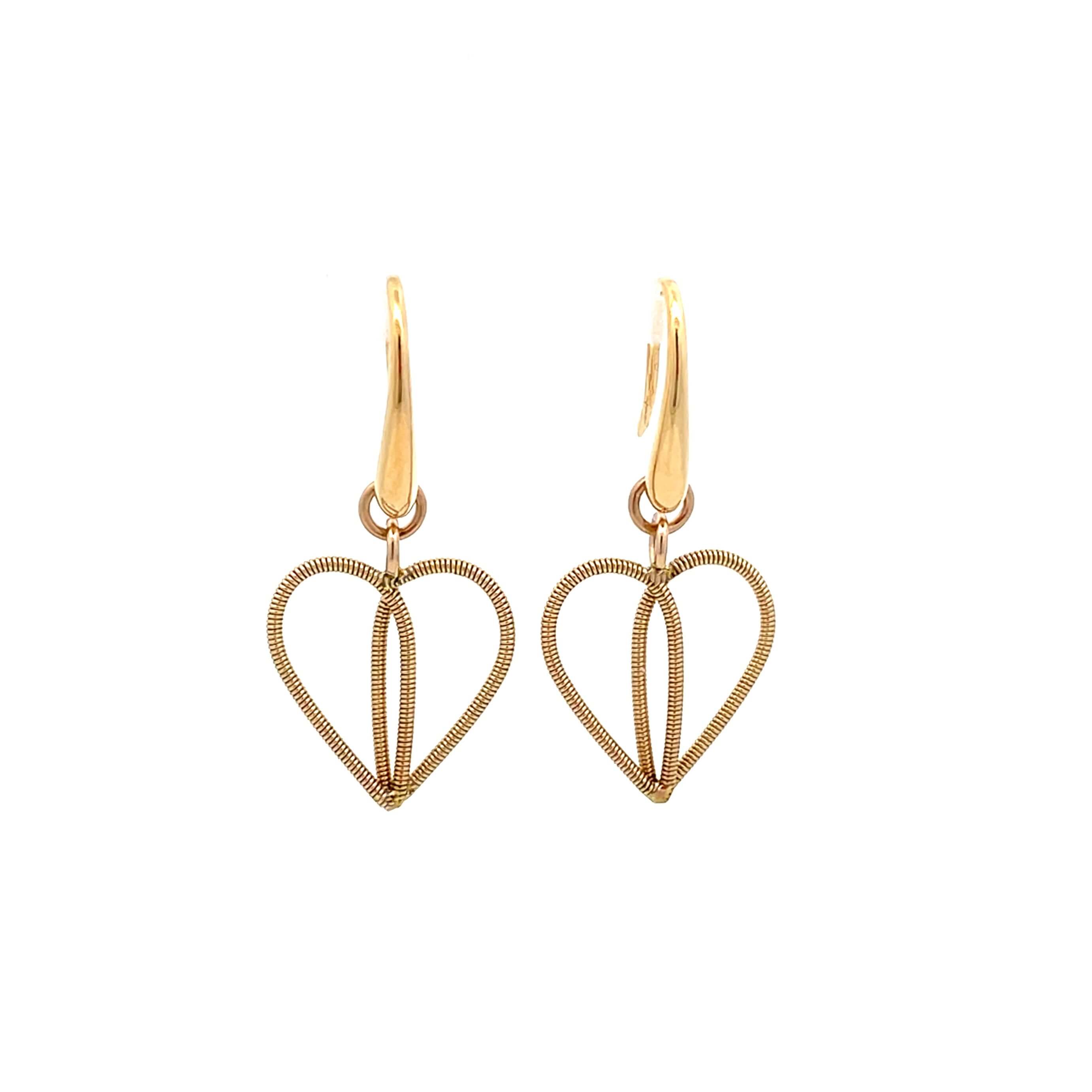 Golden guitar string heart earrings on white background