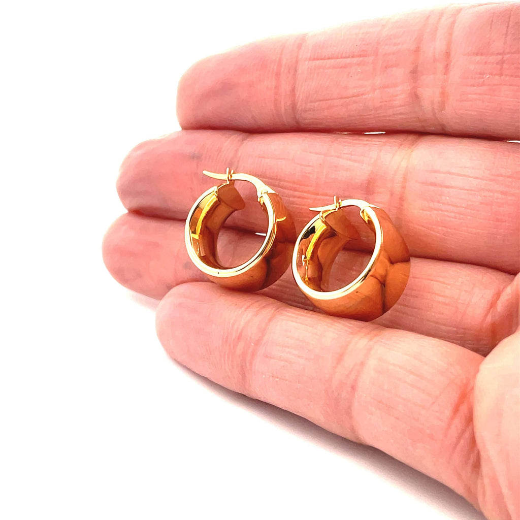 wide domed gold hoops on hand