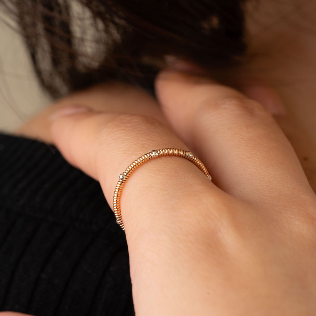 Guitar string stacking ring with silver drops on model close-up
