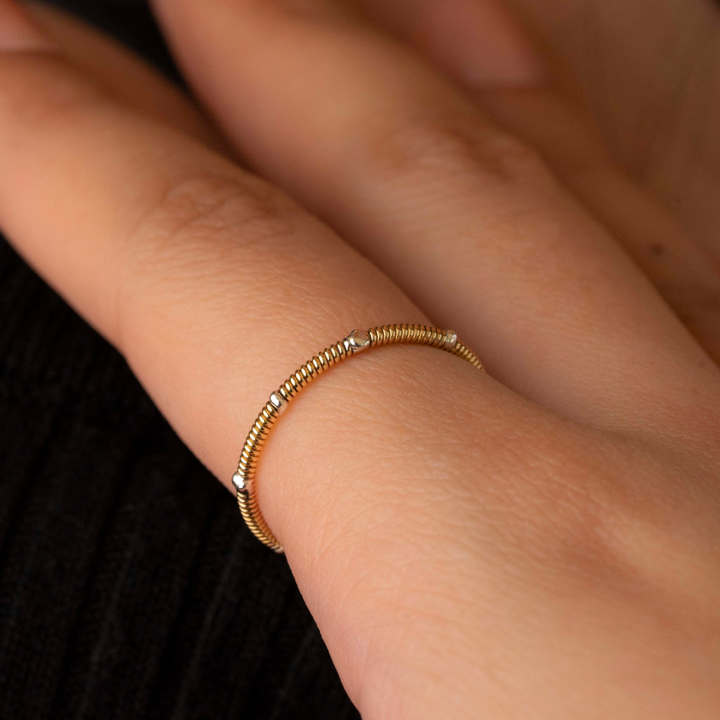 Guitar string stacking ring with silver drops on model close-up