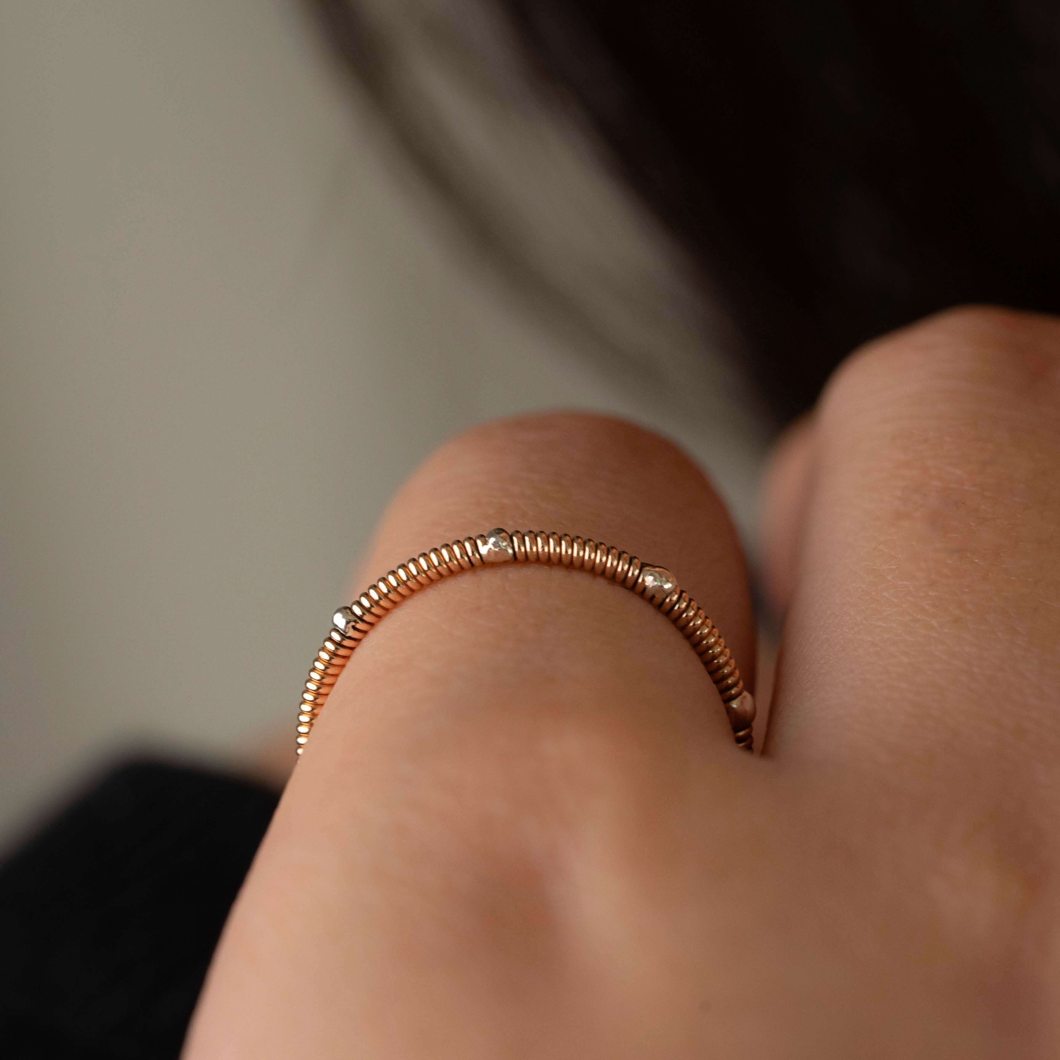 Close up of guitar string ring with silver accents on hand model