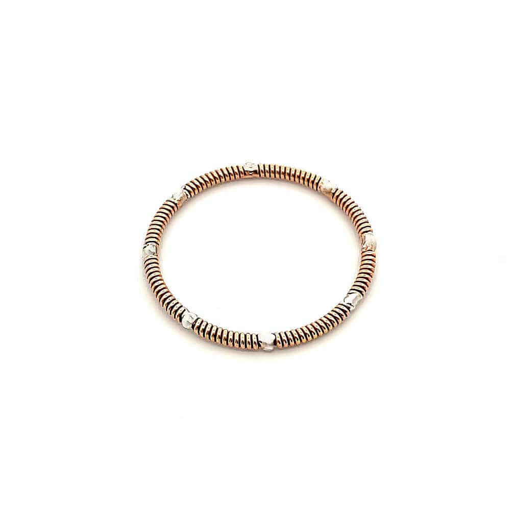 Guitar string and silver stacking ring on white background