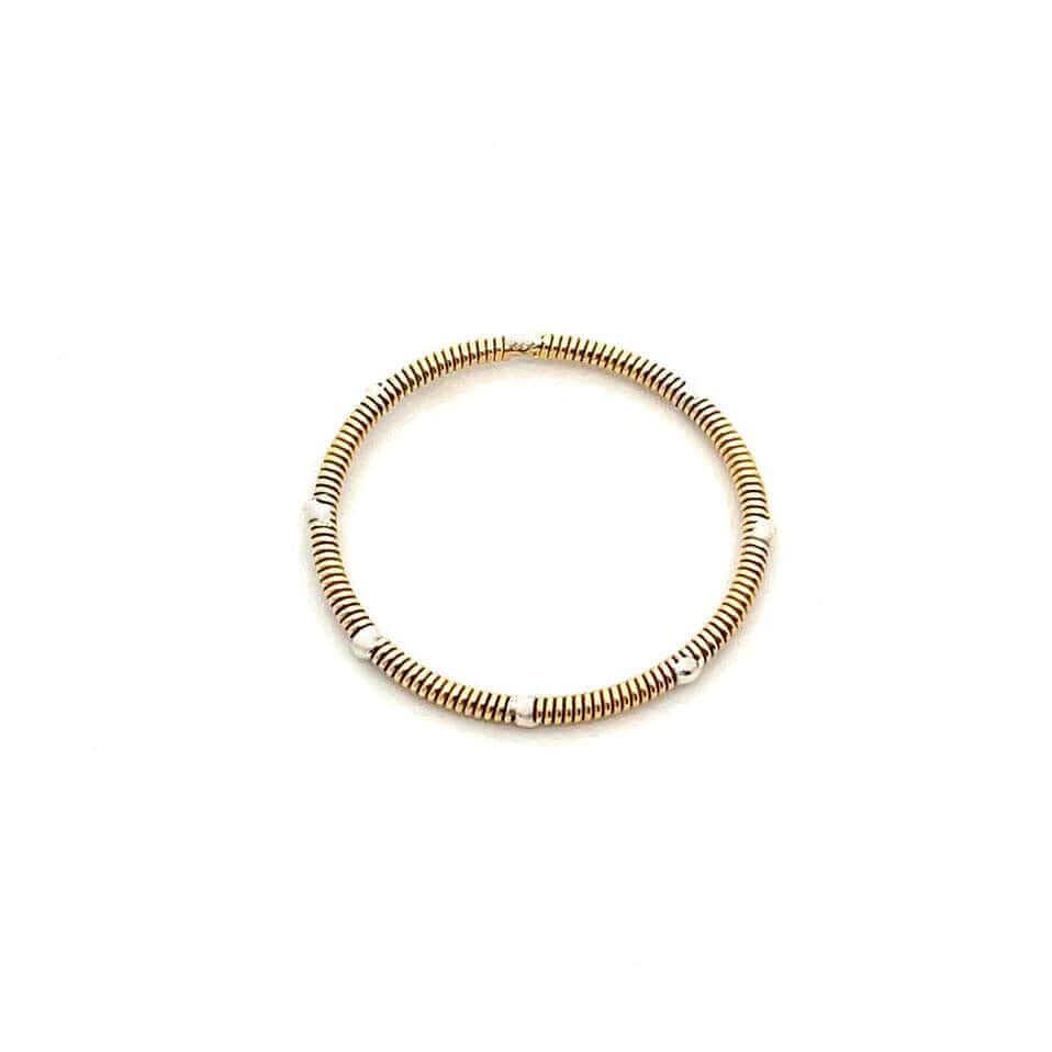 Guitar string and silver stacking ring on white background
