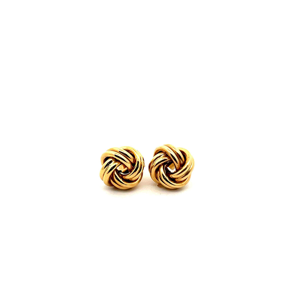 yellow gold knot earrings on white background