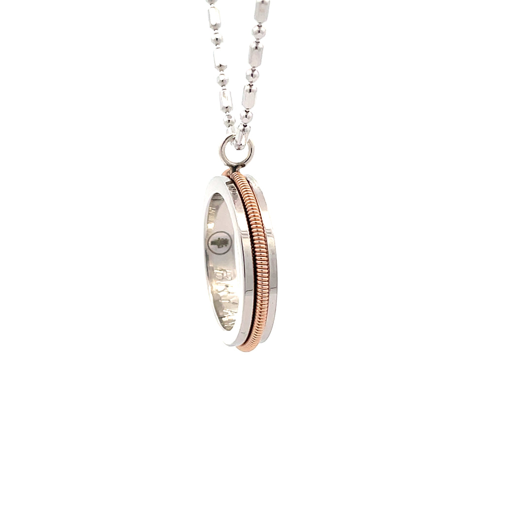 guitar string and sterling silver round pendant on a rose gold chain