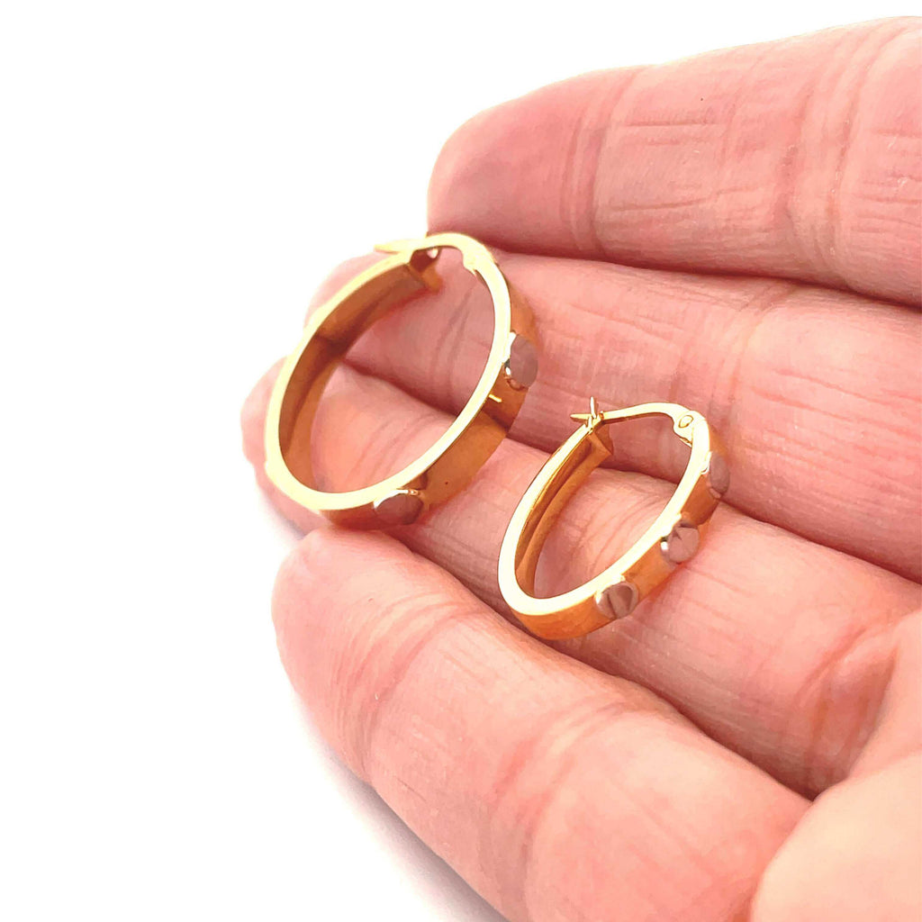 gold hoops with screw detail on hand