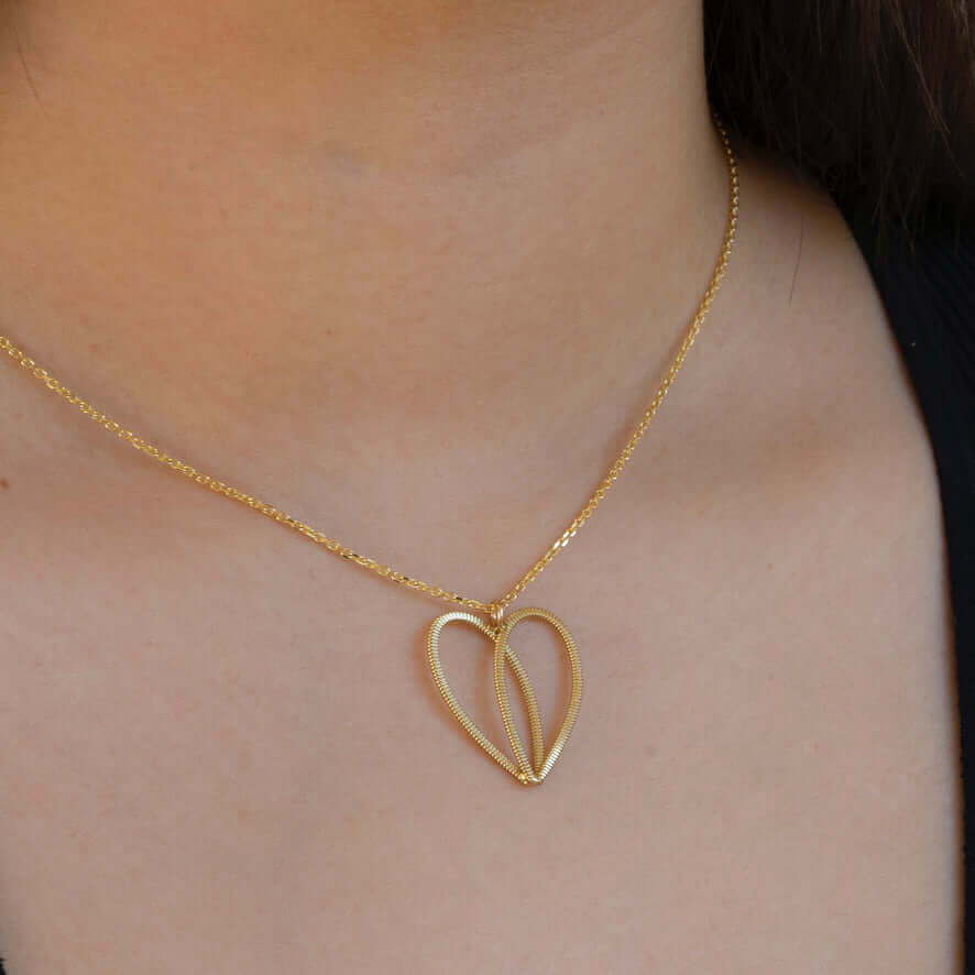 Gold guitar string heart on 10k gold chain on model