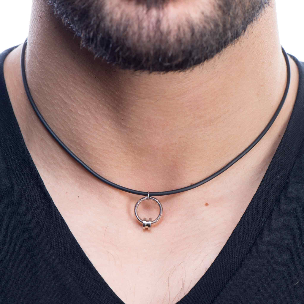 Electric and bass guitar string jewelry on model in black t-shirt