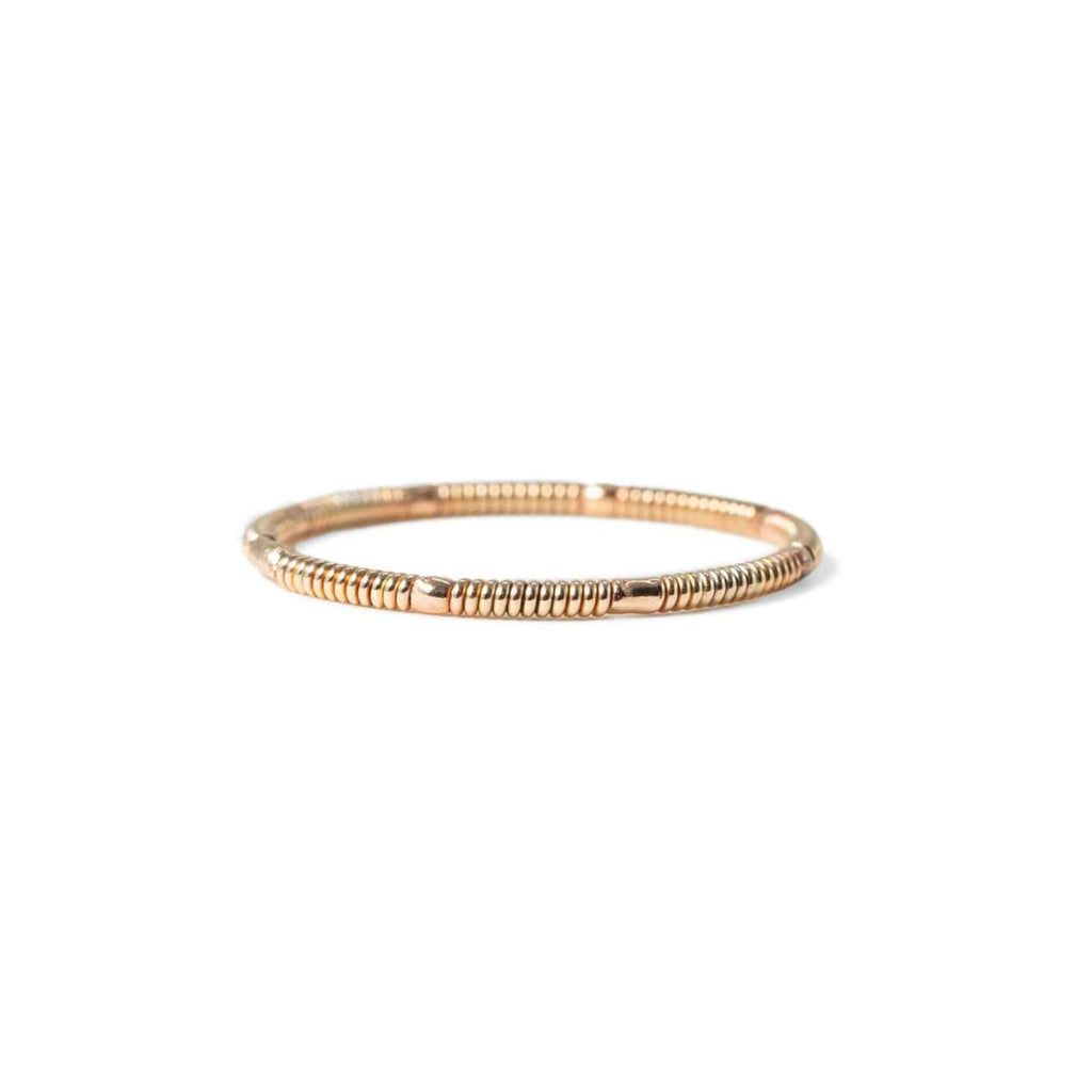 rose gold colored acoustic guitar string ring on white background