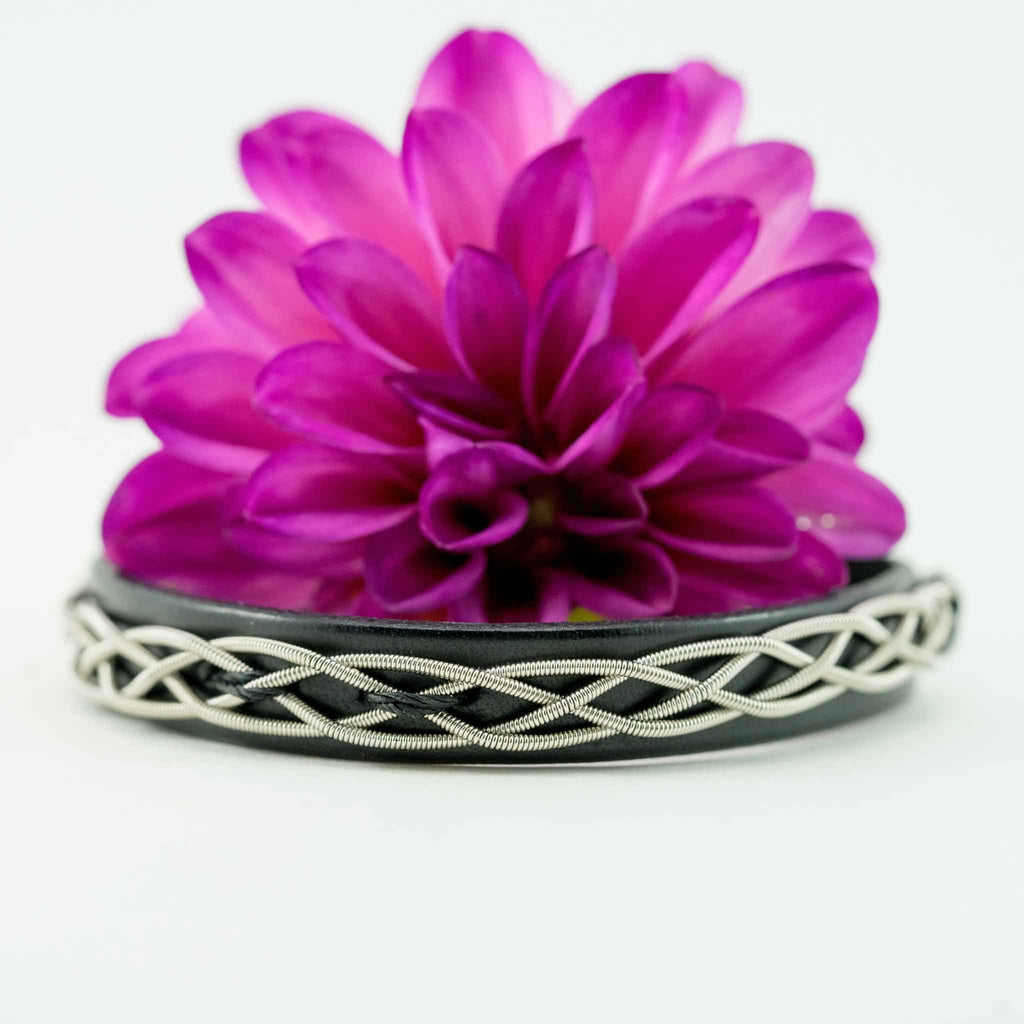 black electric guitar string and leather bracelet with pink flower