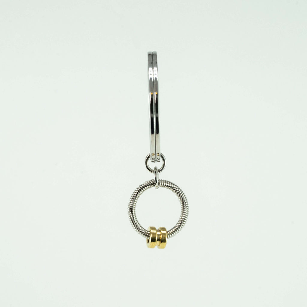 gold bass guitar string keychain on a white background