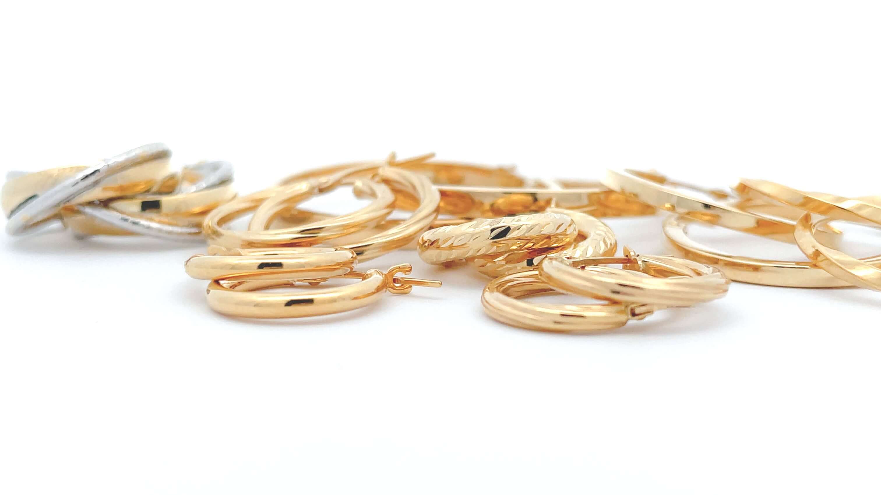 14k gold paperclip chains in 3 sizes on a white bakcground