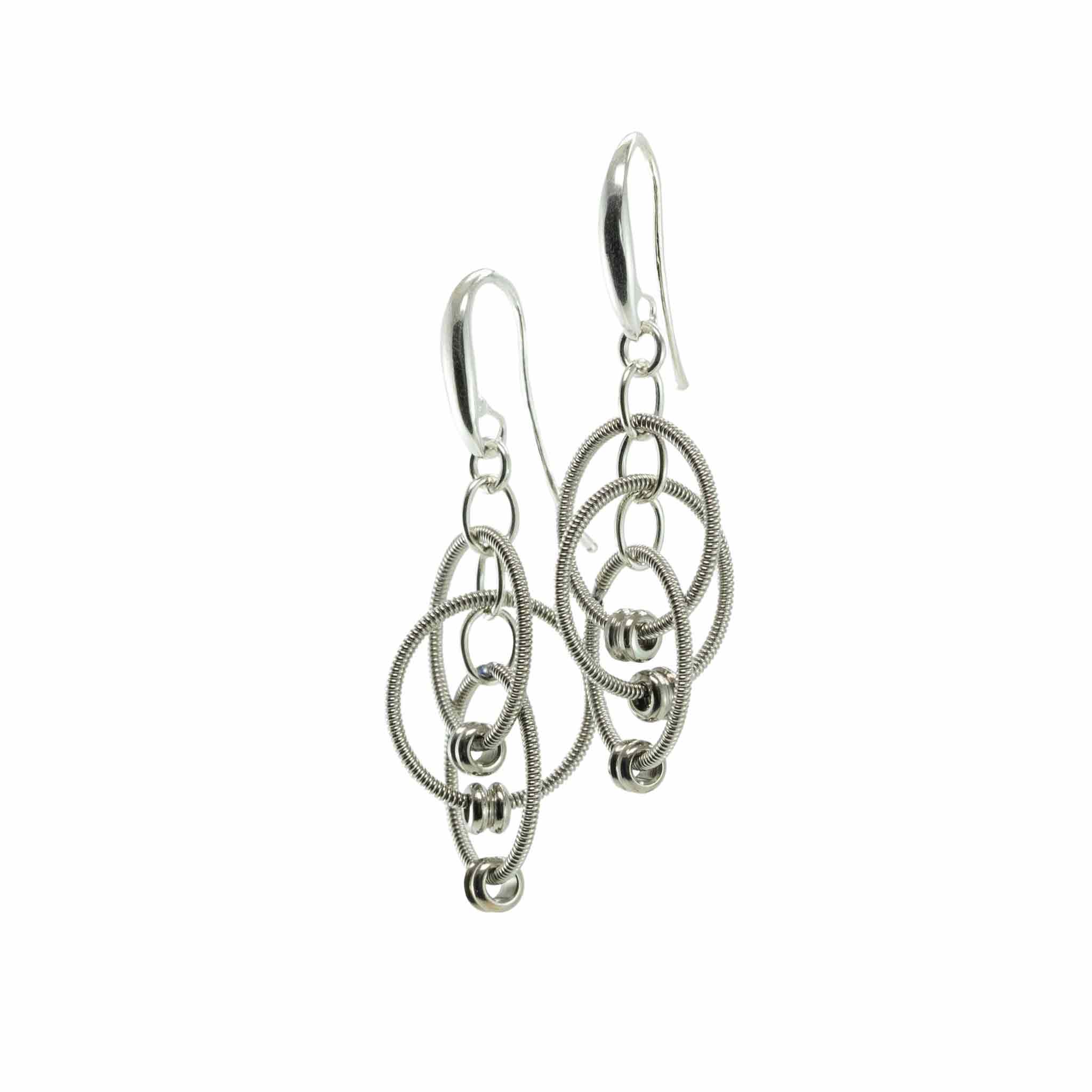 Reclaimed guitar string stud, knot earrings on a white background