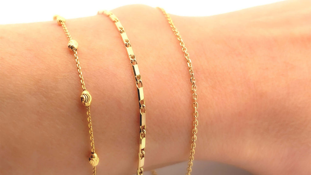 chains for permanent jewelry draped across an arm