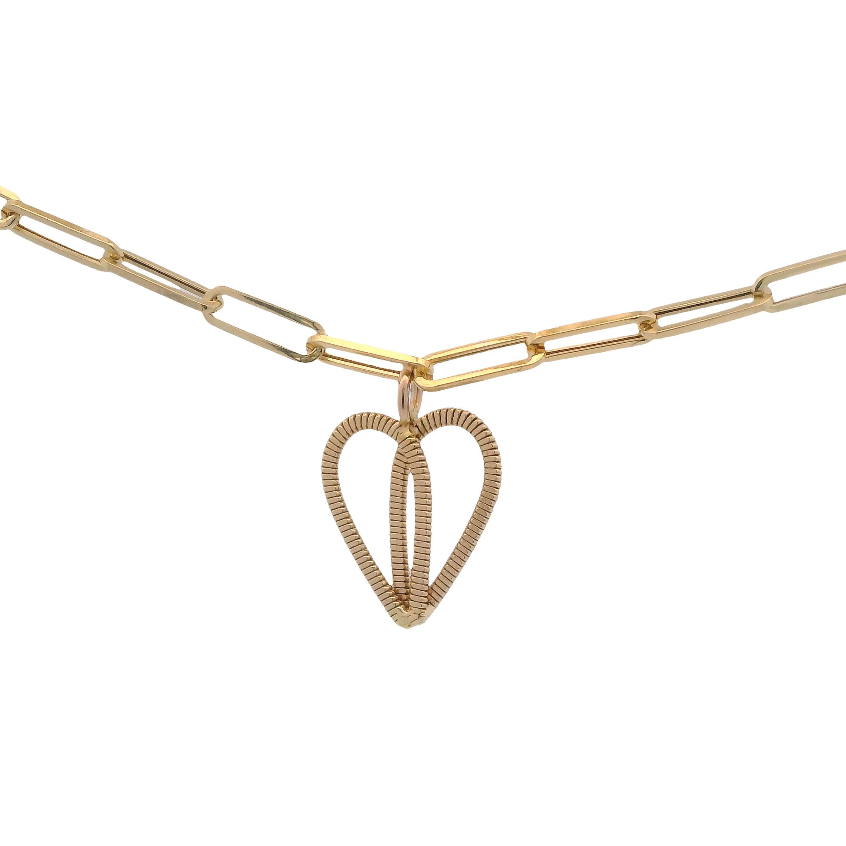 Gold guitar string heart on gold paperclip chain with white background.