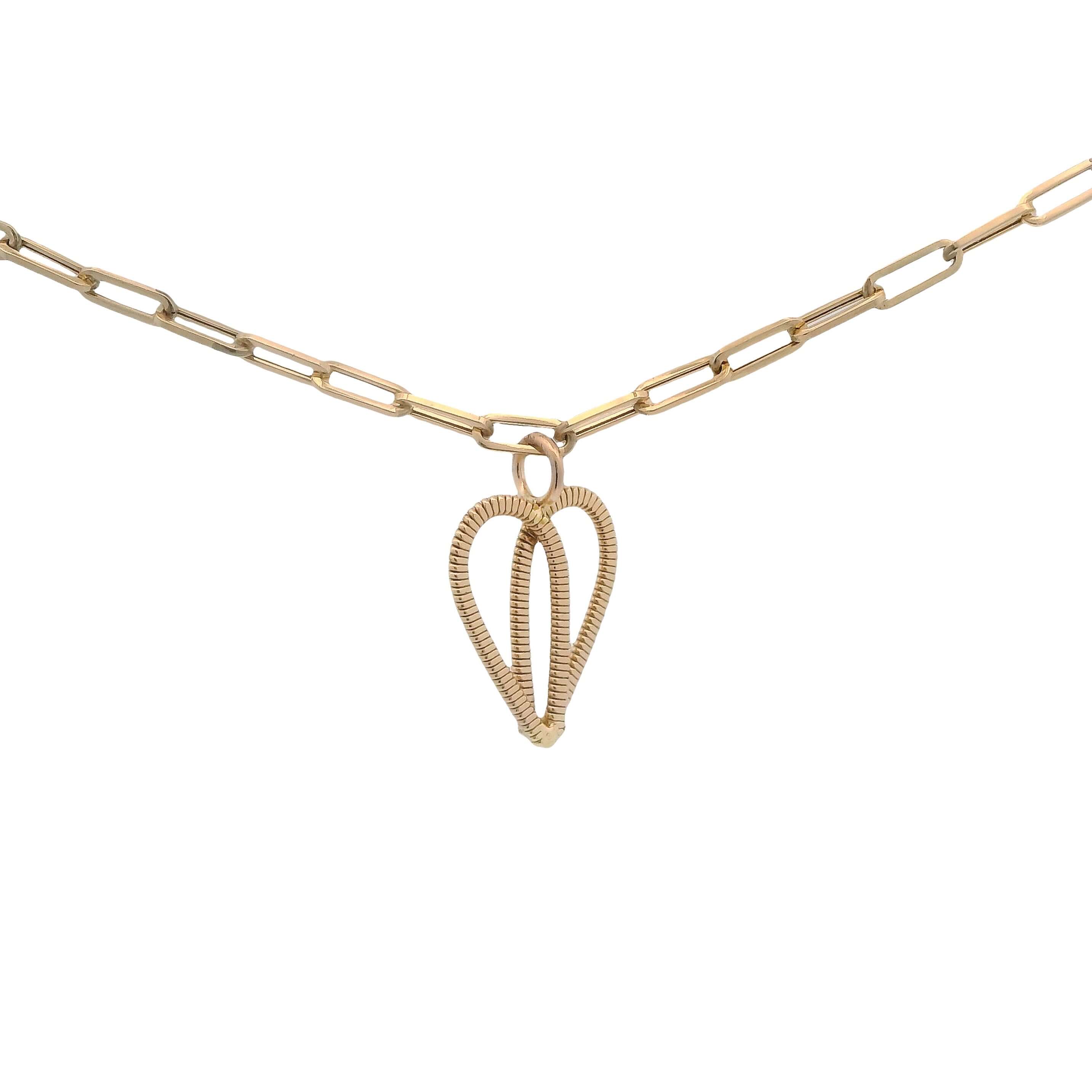 Gold guitar string heart on gold paperclip chain with white background.