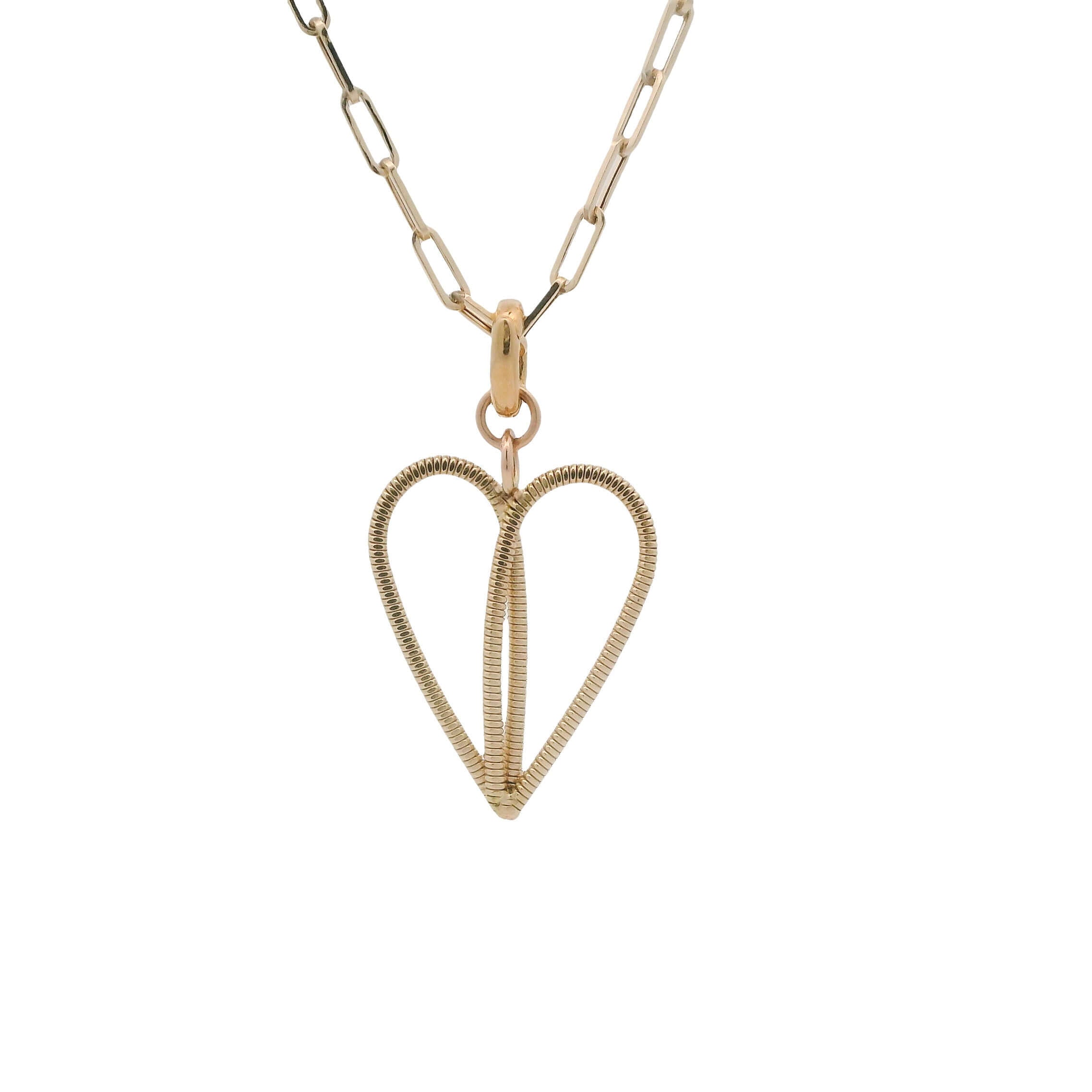 Gold heart made of guitar string on a gold paperclip chain with white background