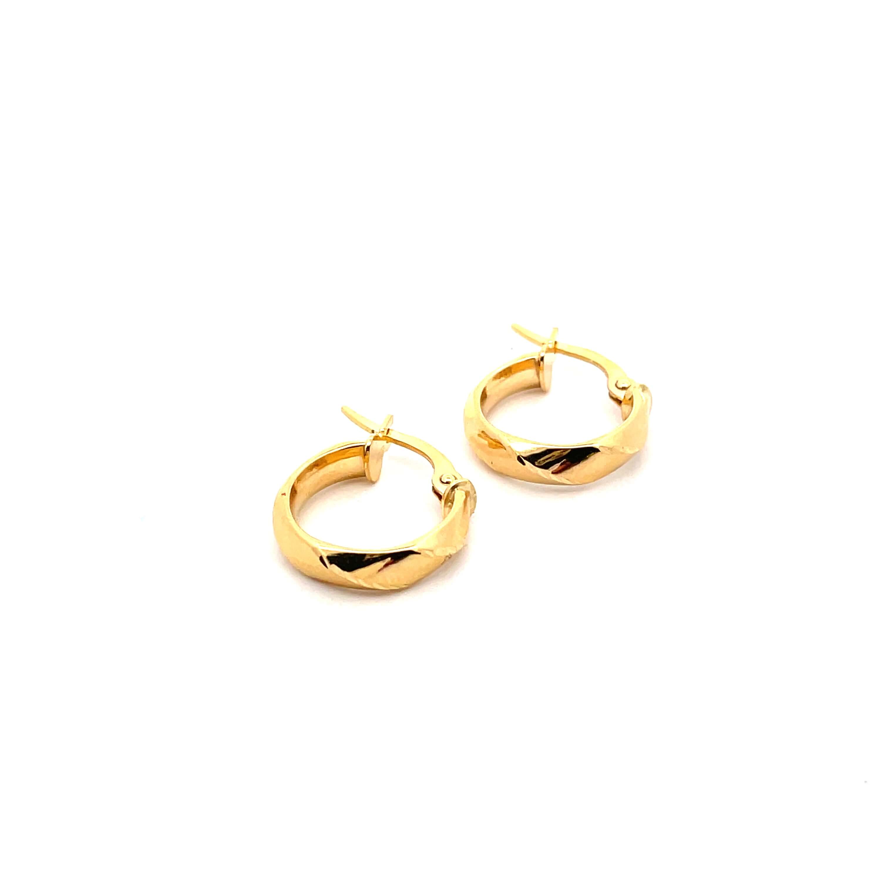 Harlequin mini gold hoops on white background