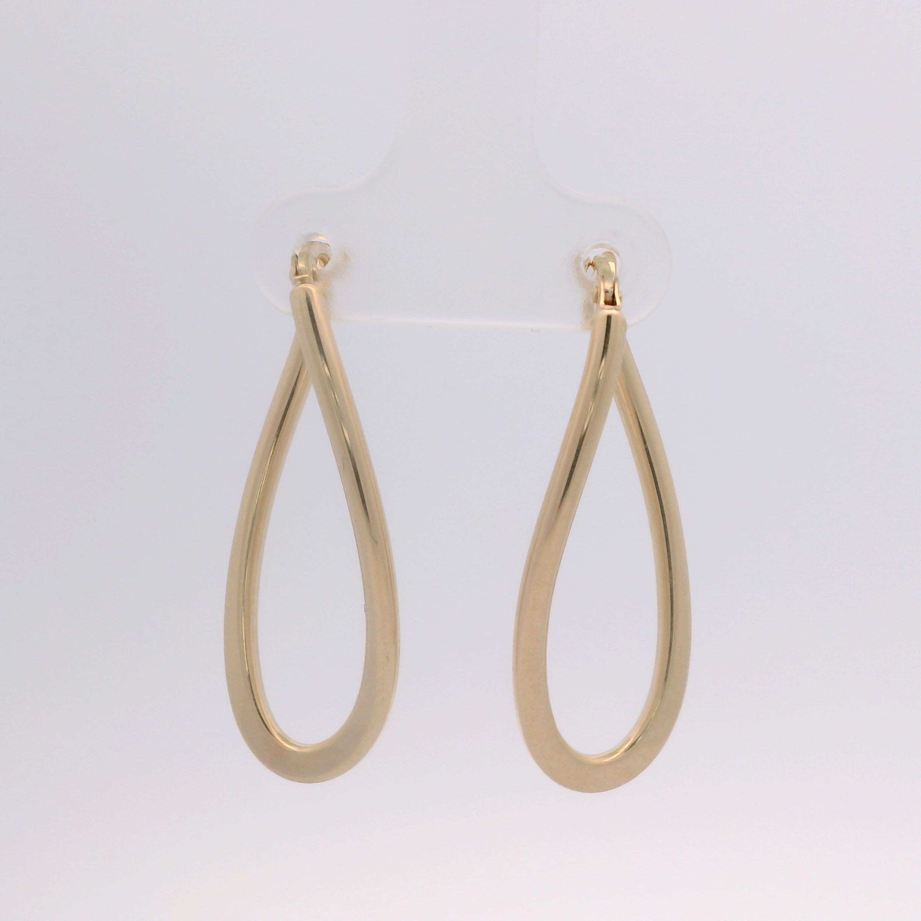 Gold hoop earrings on a light gray background