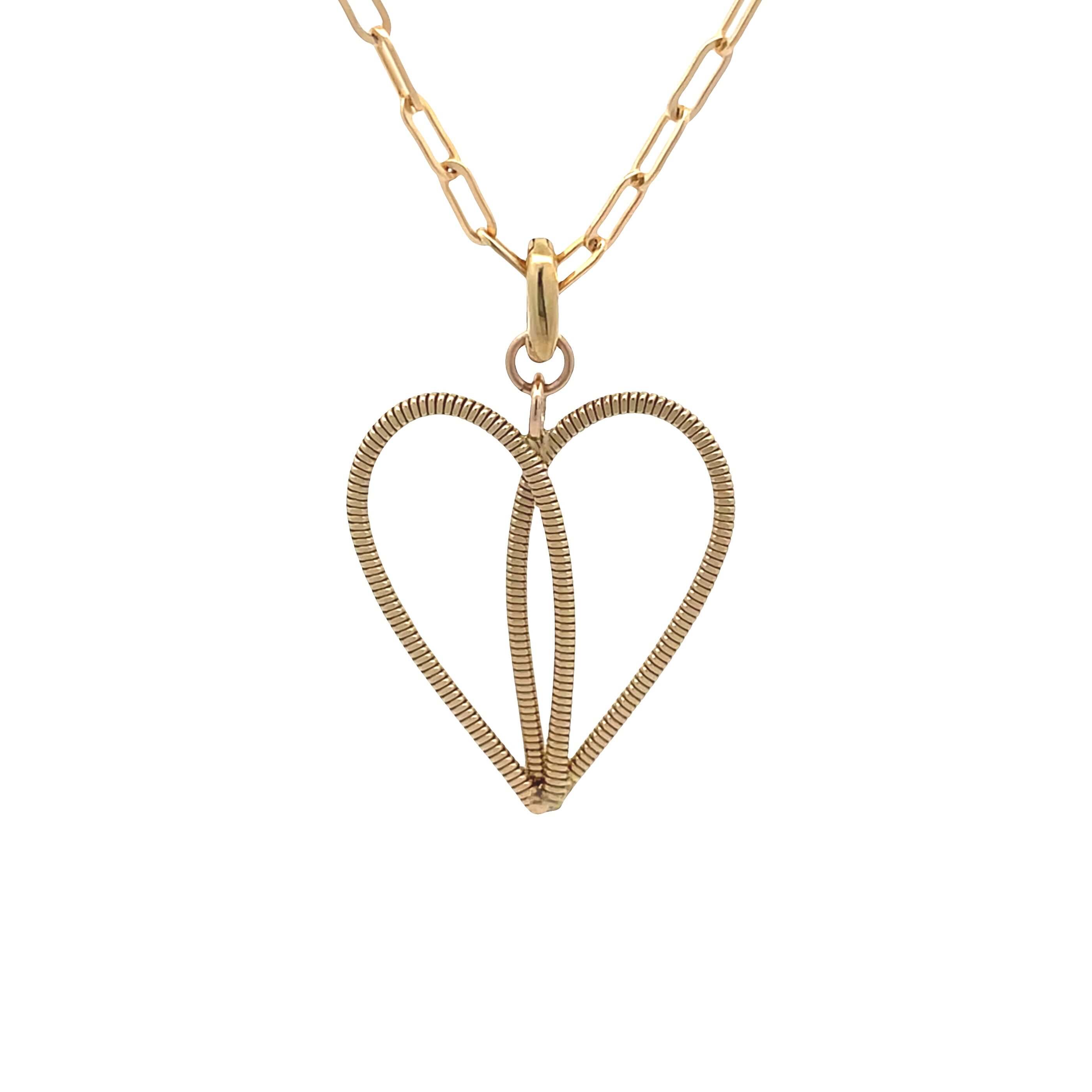 Gold guitar string necklace on paperclip chain with a white background.