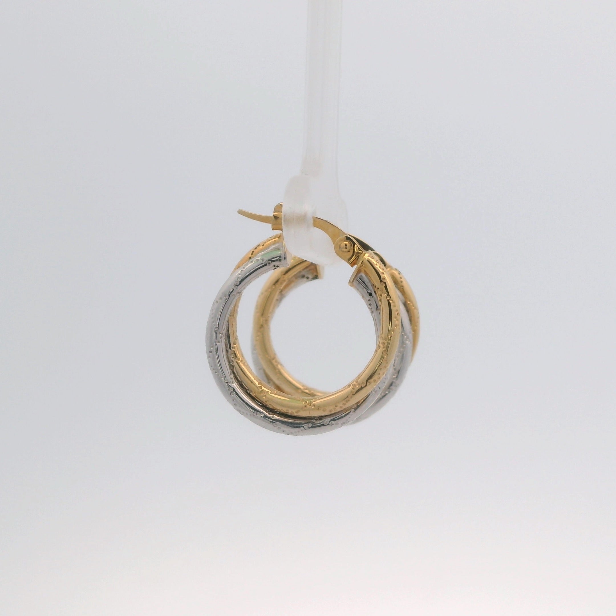 Two gold hoop earrings on a white background