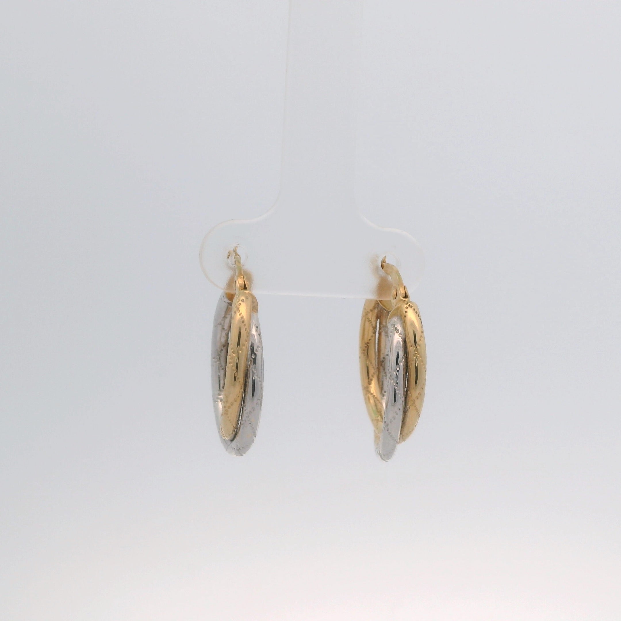 Gold and silver hoop earrings on a white background