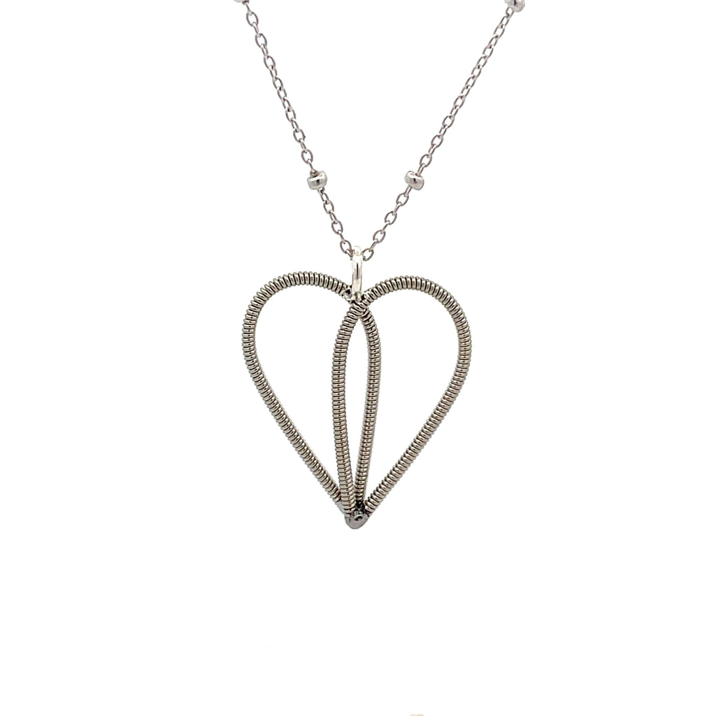 White gold necklace with guitar string heart on white background.