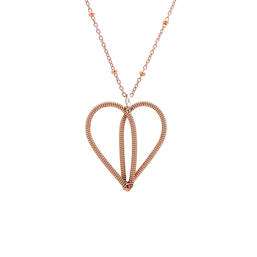 Sarah McLachlan guitar string heart on rose gold chain with white background