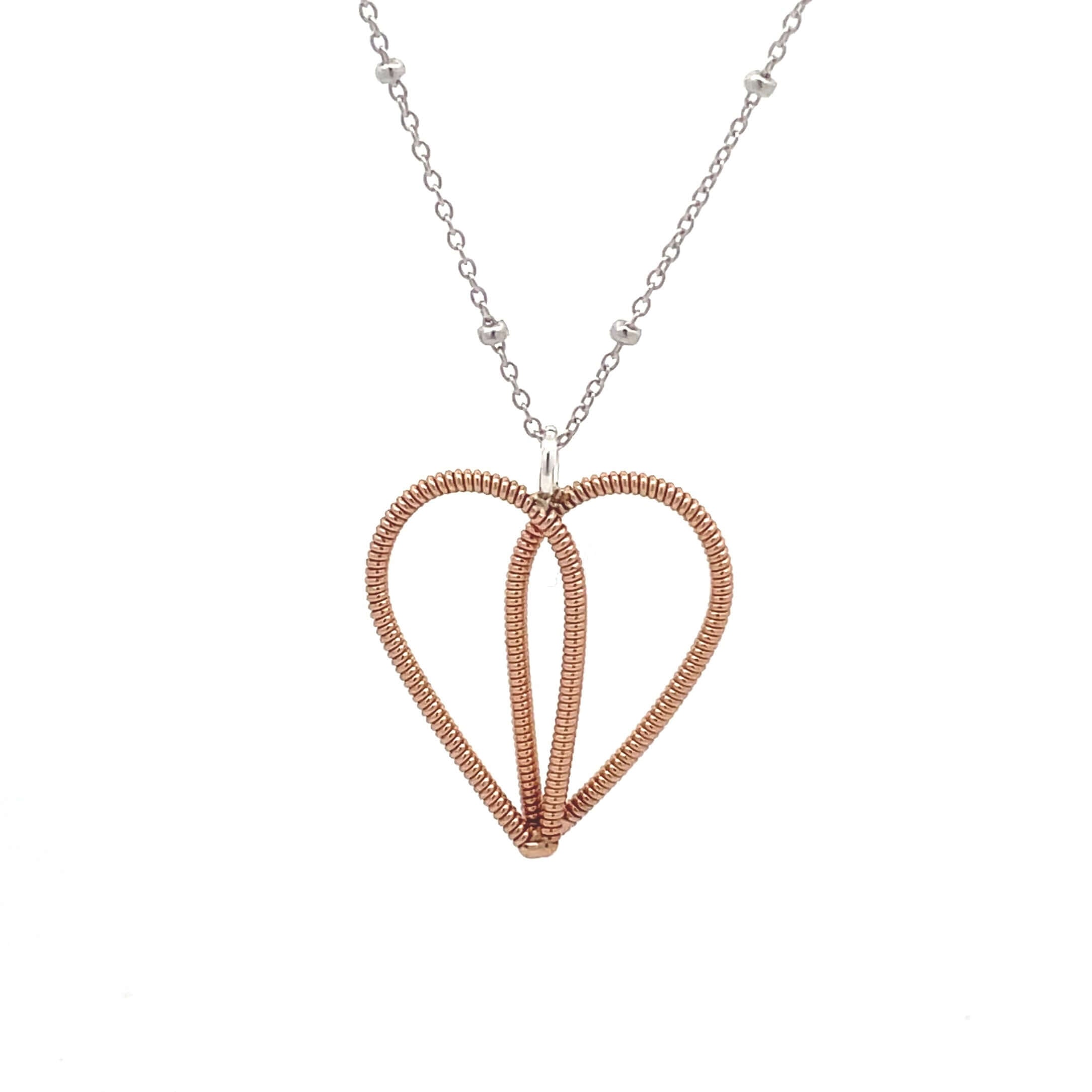 Bronze guitar string heart on white gold chain with white background.