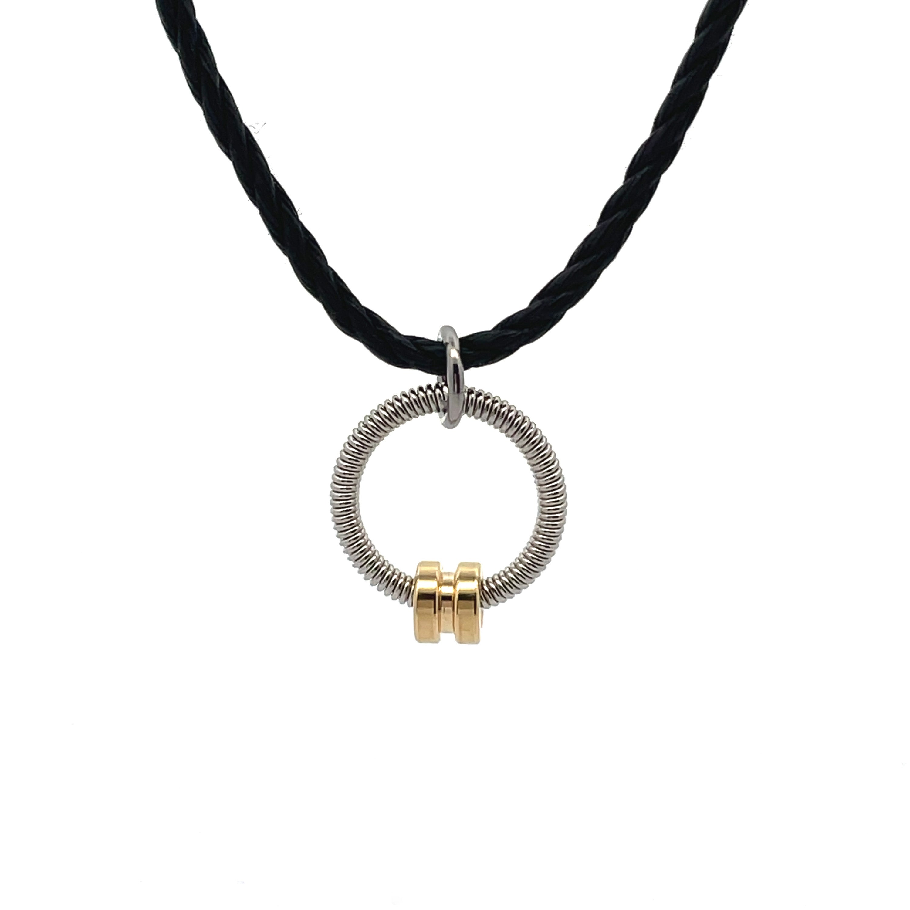 bass guitar string circle pendant with brass accent on black cord.