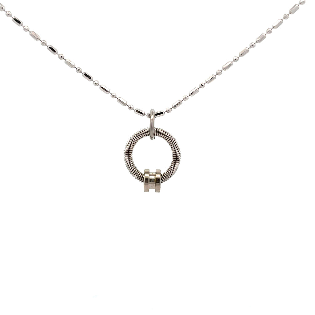 Bass guitar string necklace with silver ball end on white background