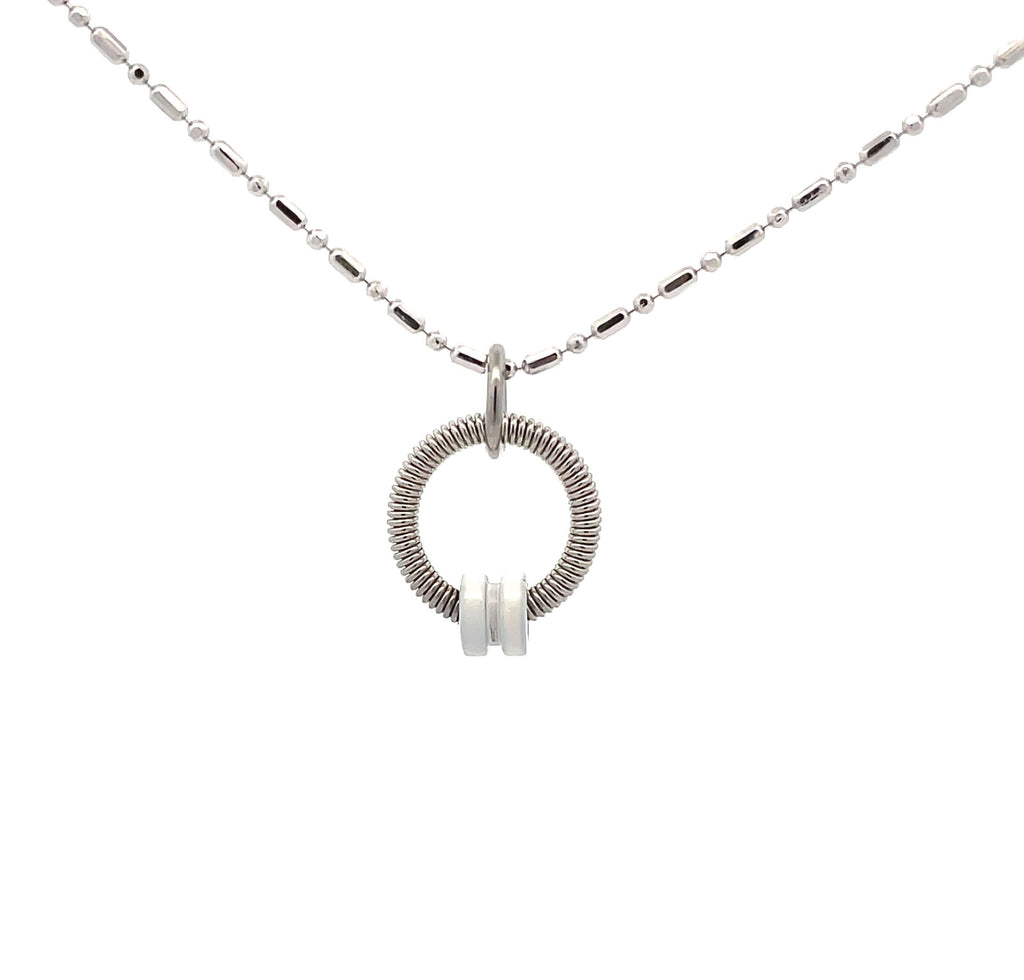 Bass guitar string necklace with white ball end on white background