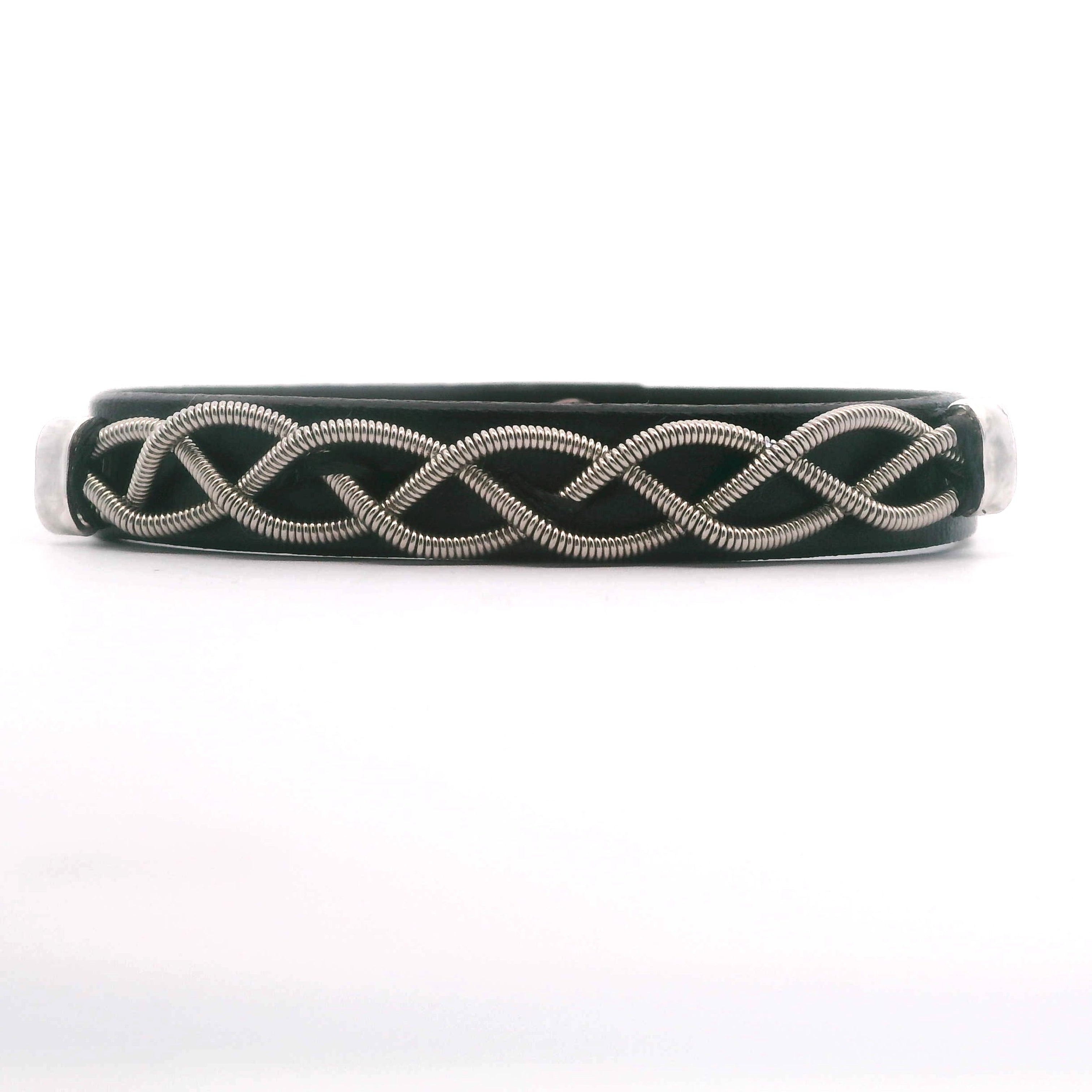 electric base guitar string and black leather bracelet on white background