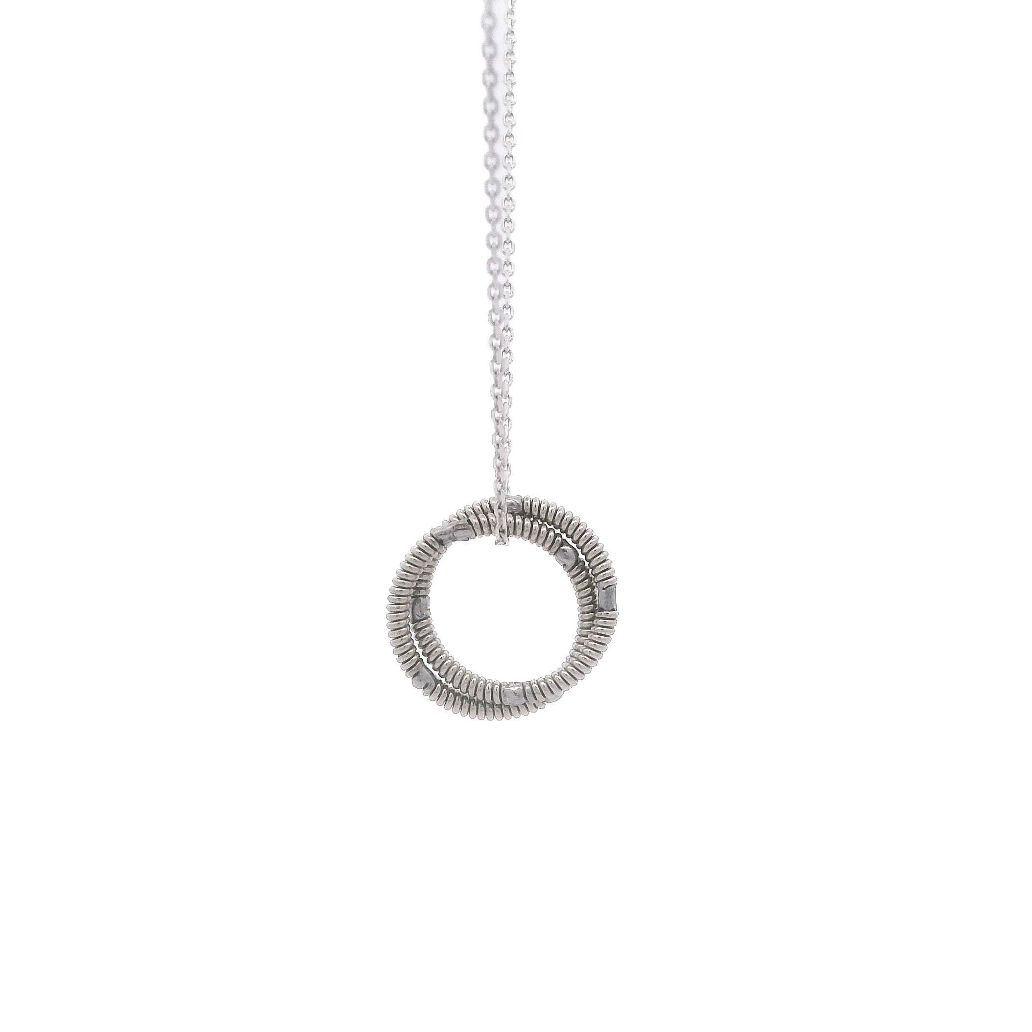 electric guitar string round pendant on 10K white gold chain hanging on a white background