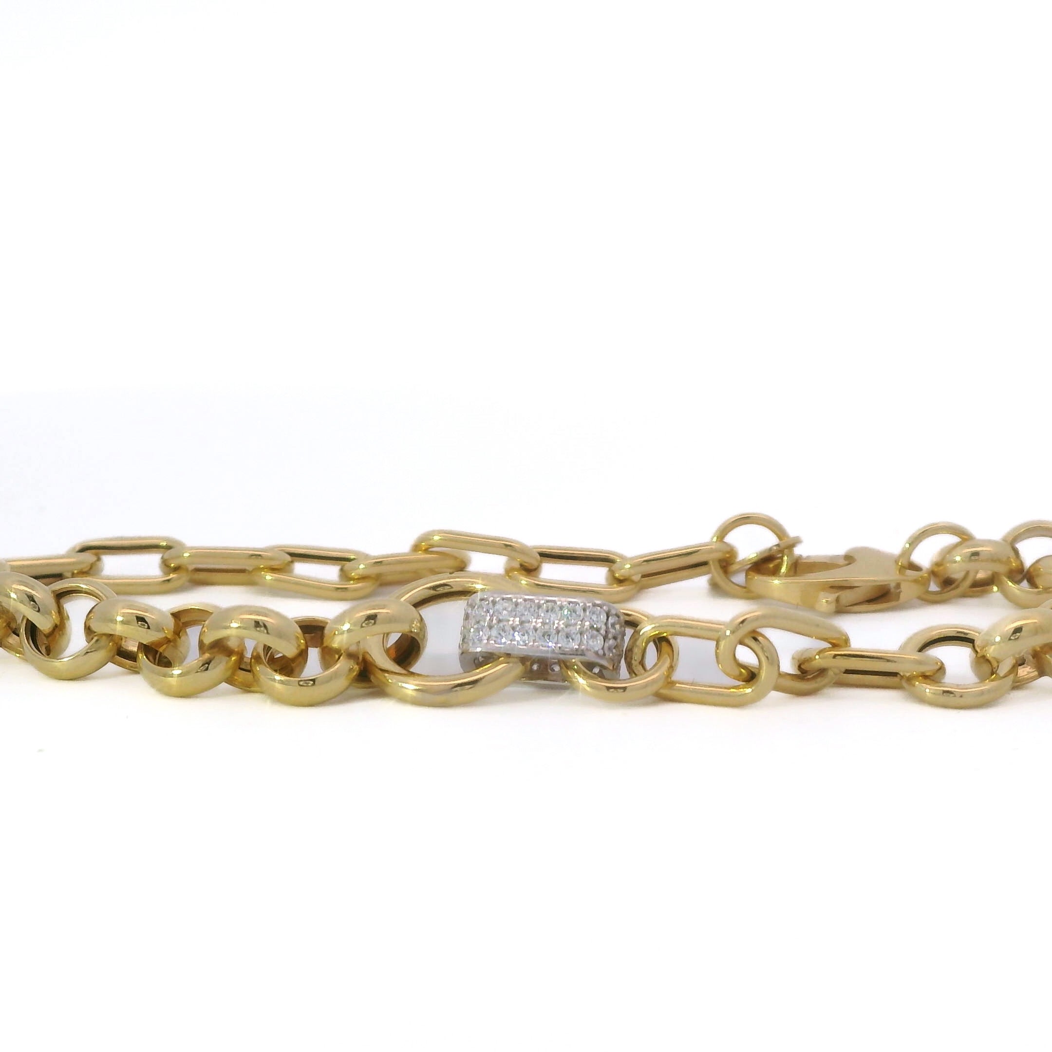 Gold rolo chain bracelet with a cz-encrusted clasp on a white background