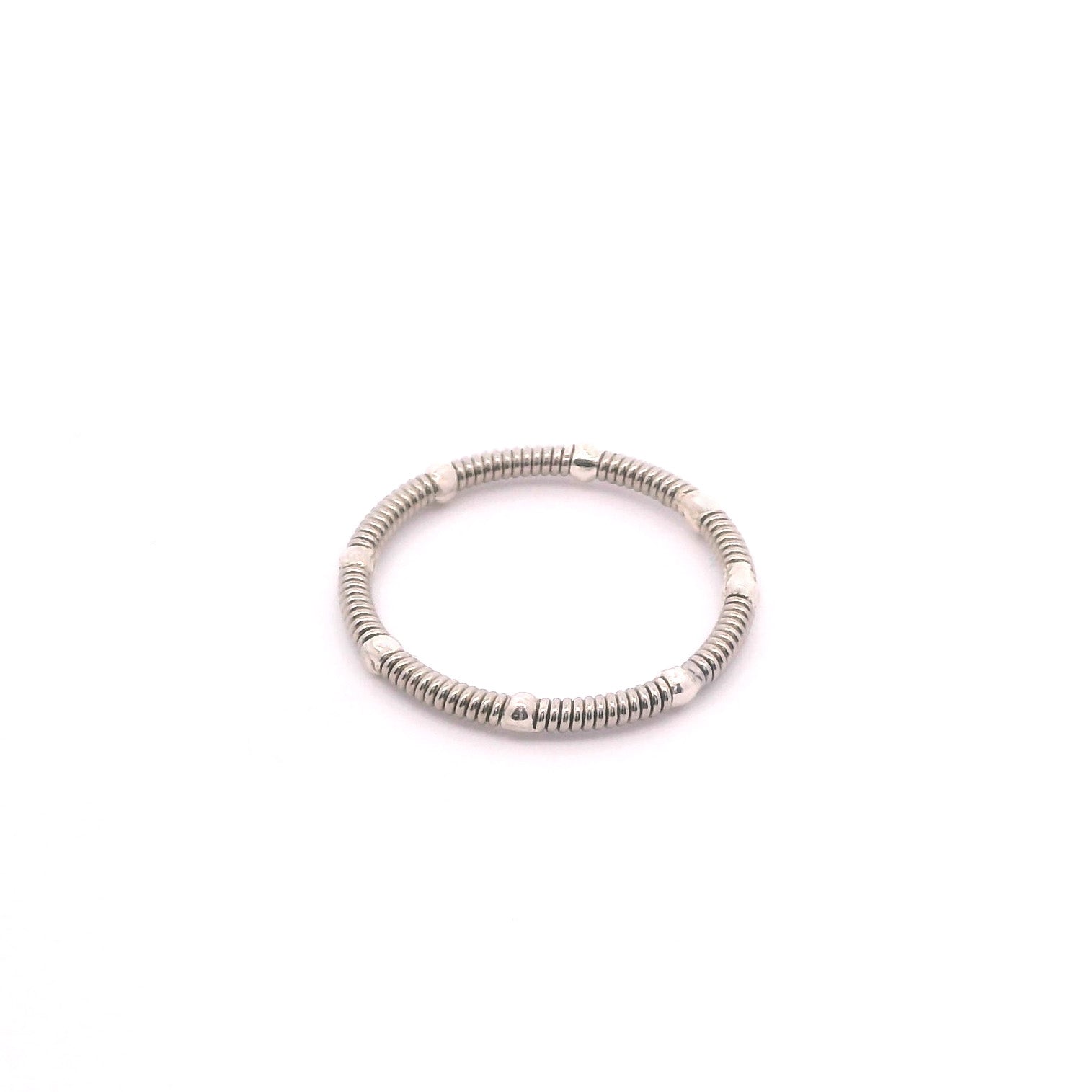 Guitar string and silver stacking ring on white background
