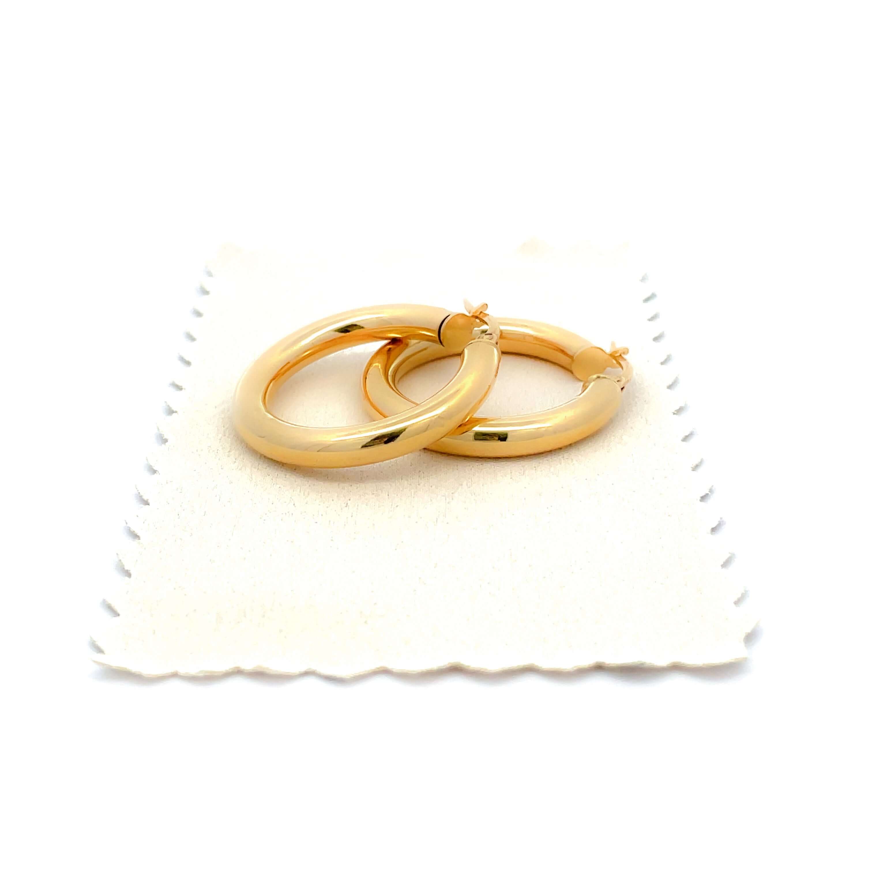 gold hoop earrings on gold polishing cloth