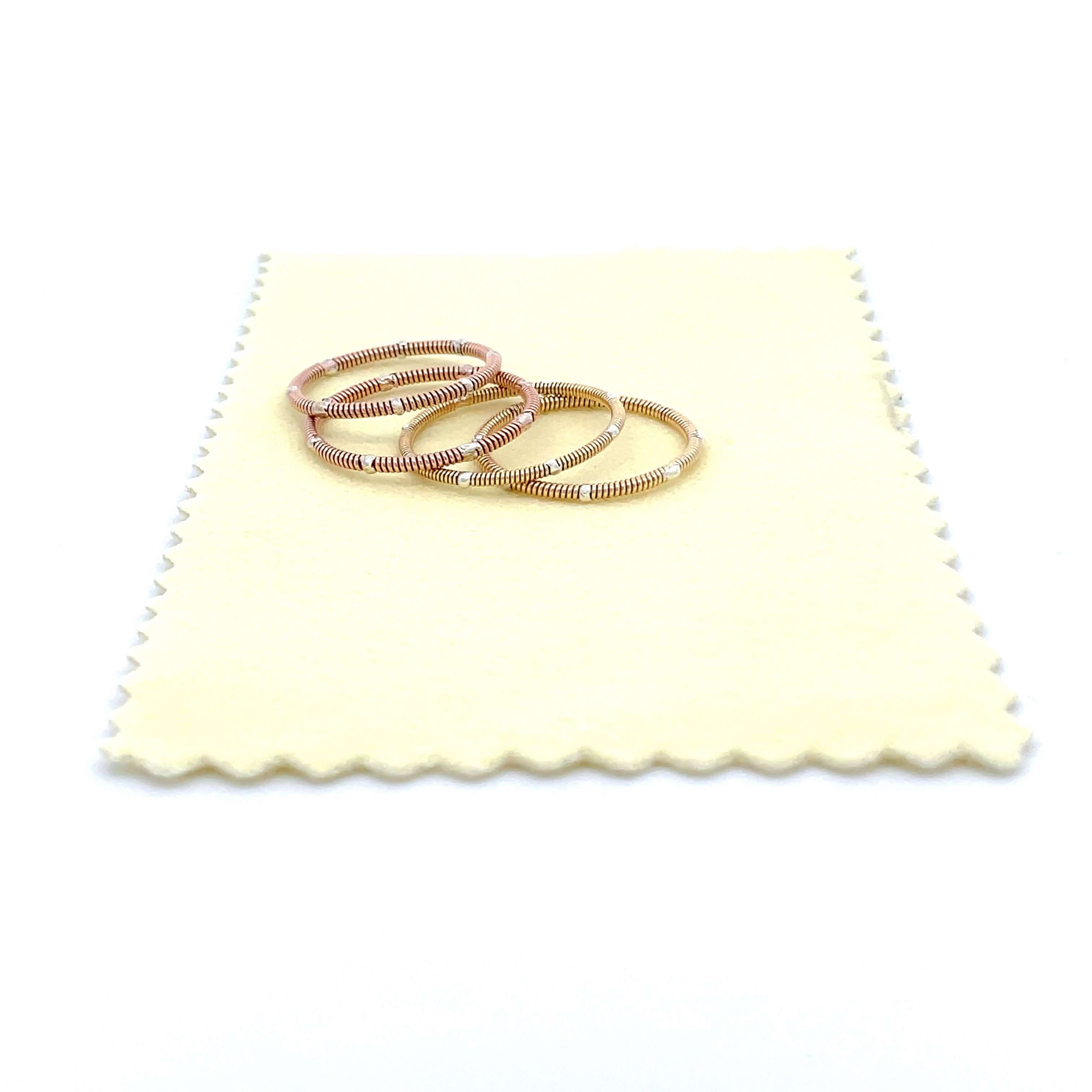 guitar string rings laying on yellow polishing cloth