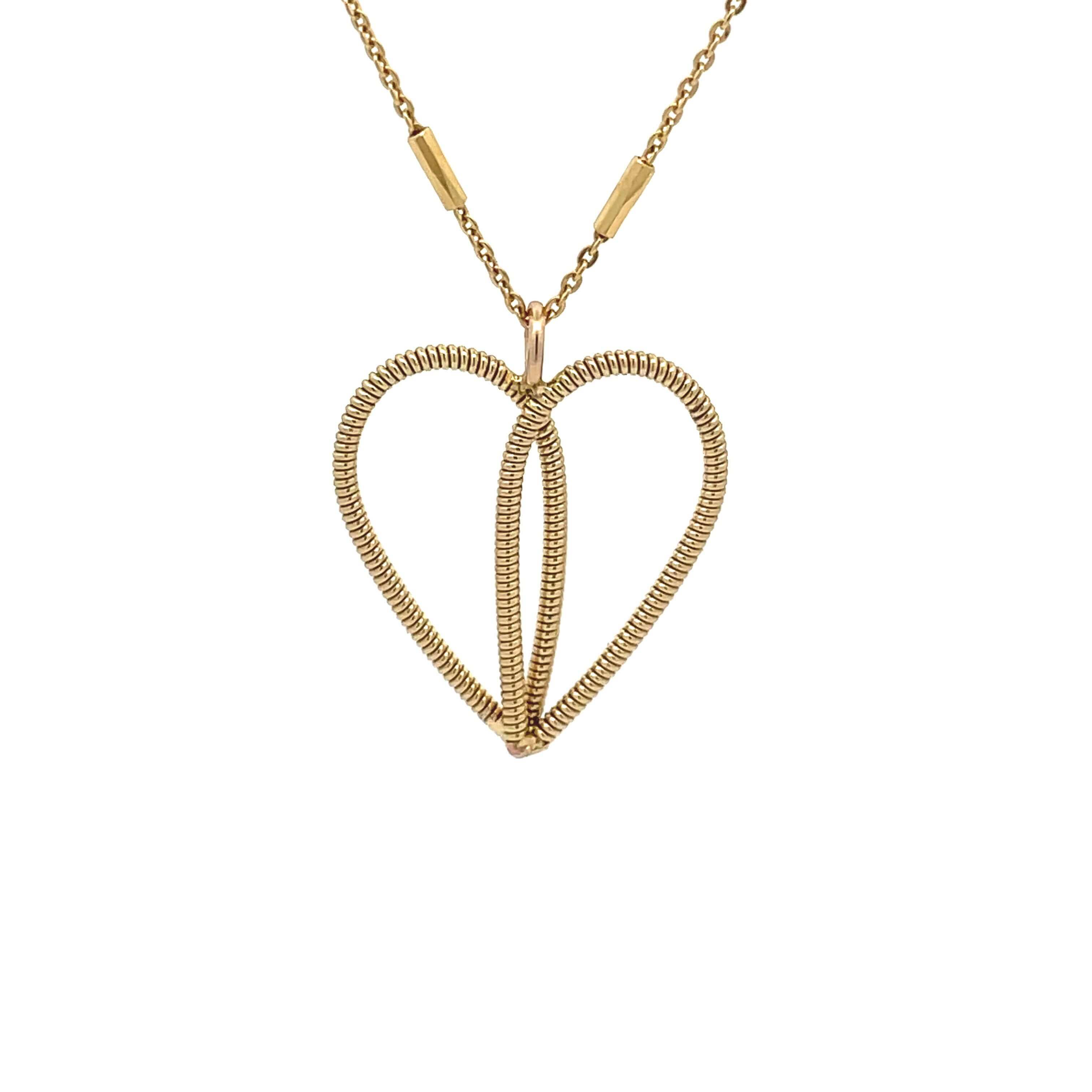 Guitar string gold heart necklace on white background