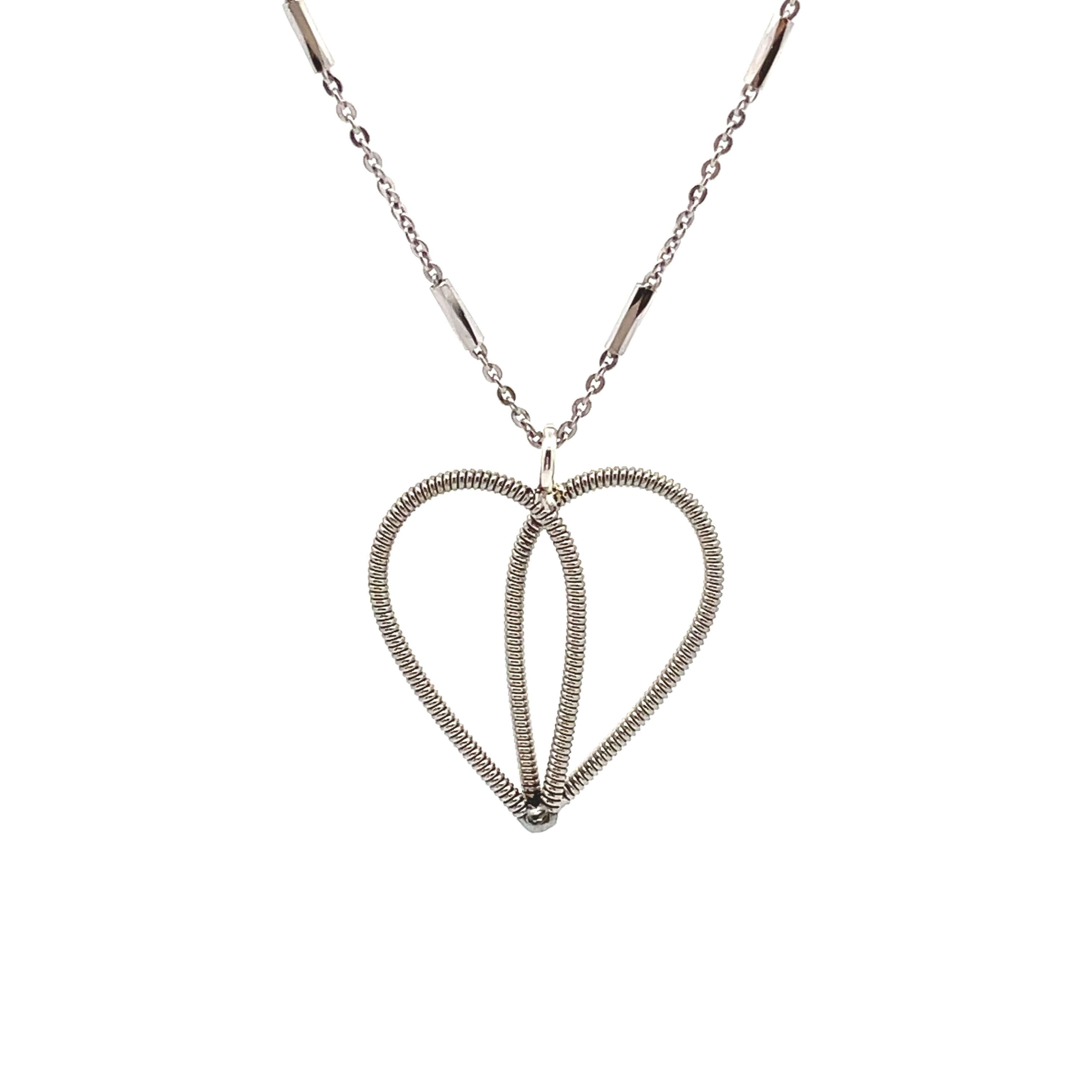 White gold guitar string heart necklace on white background.