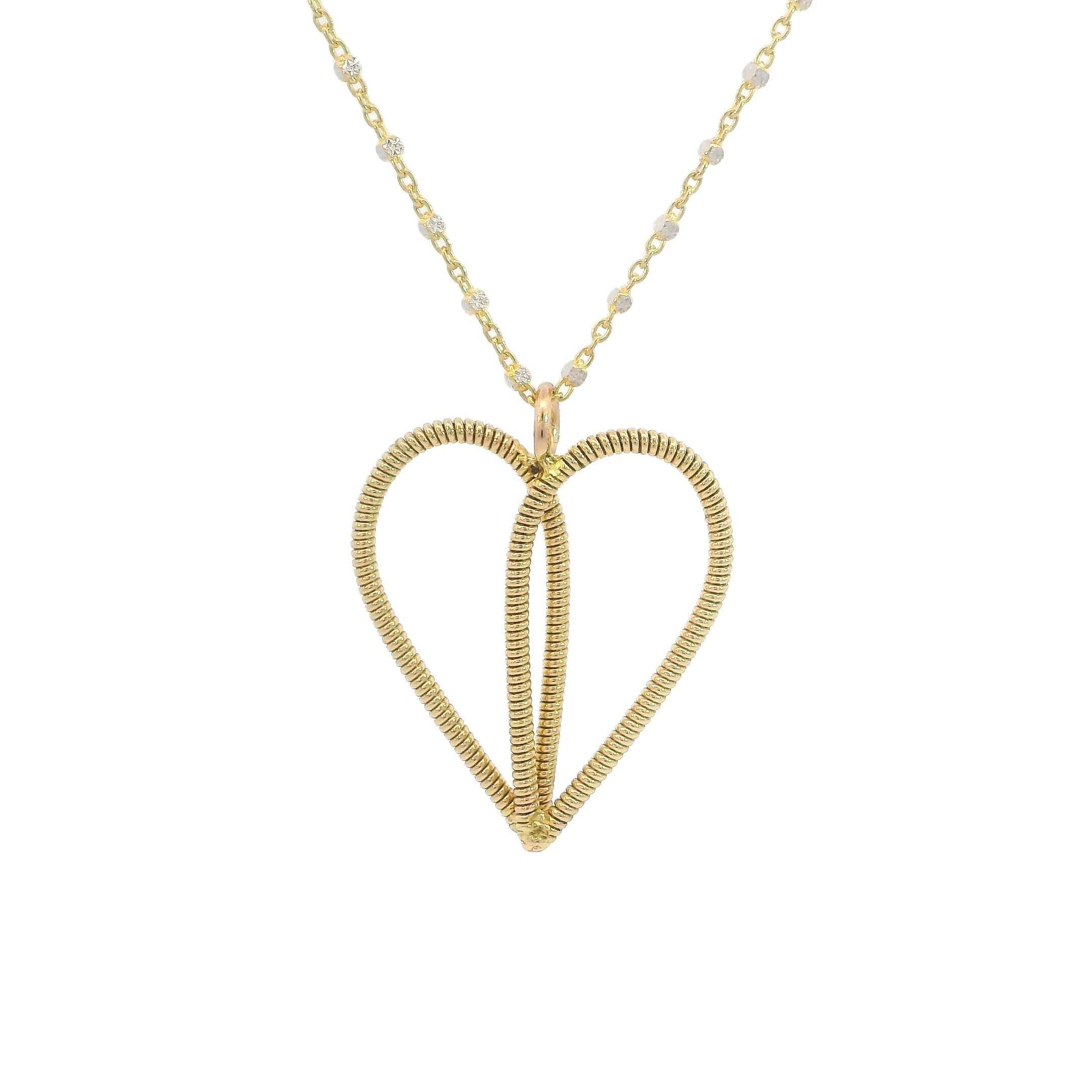 Gold guitar string heart necklace on white background