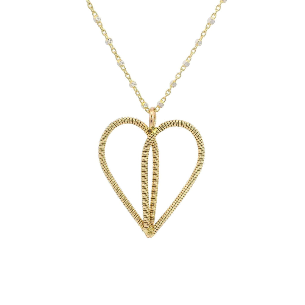 Gold guitar string heart necklace on white background