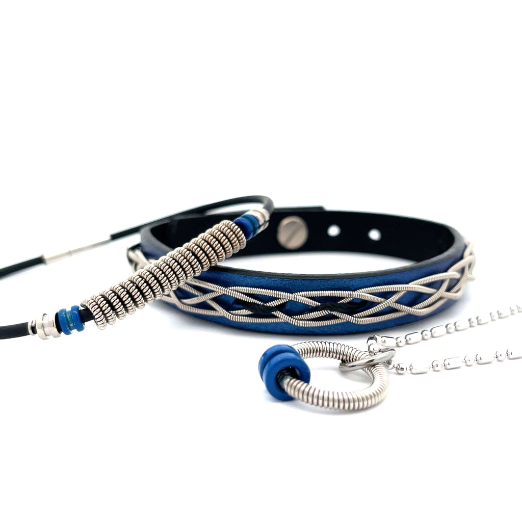 Blue leather electric guitar string bracelets and necklace on white background