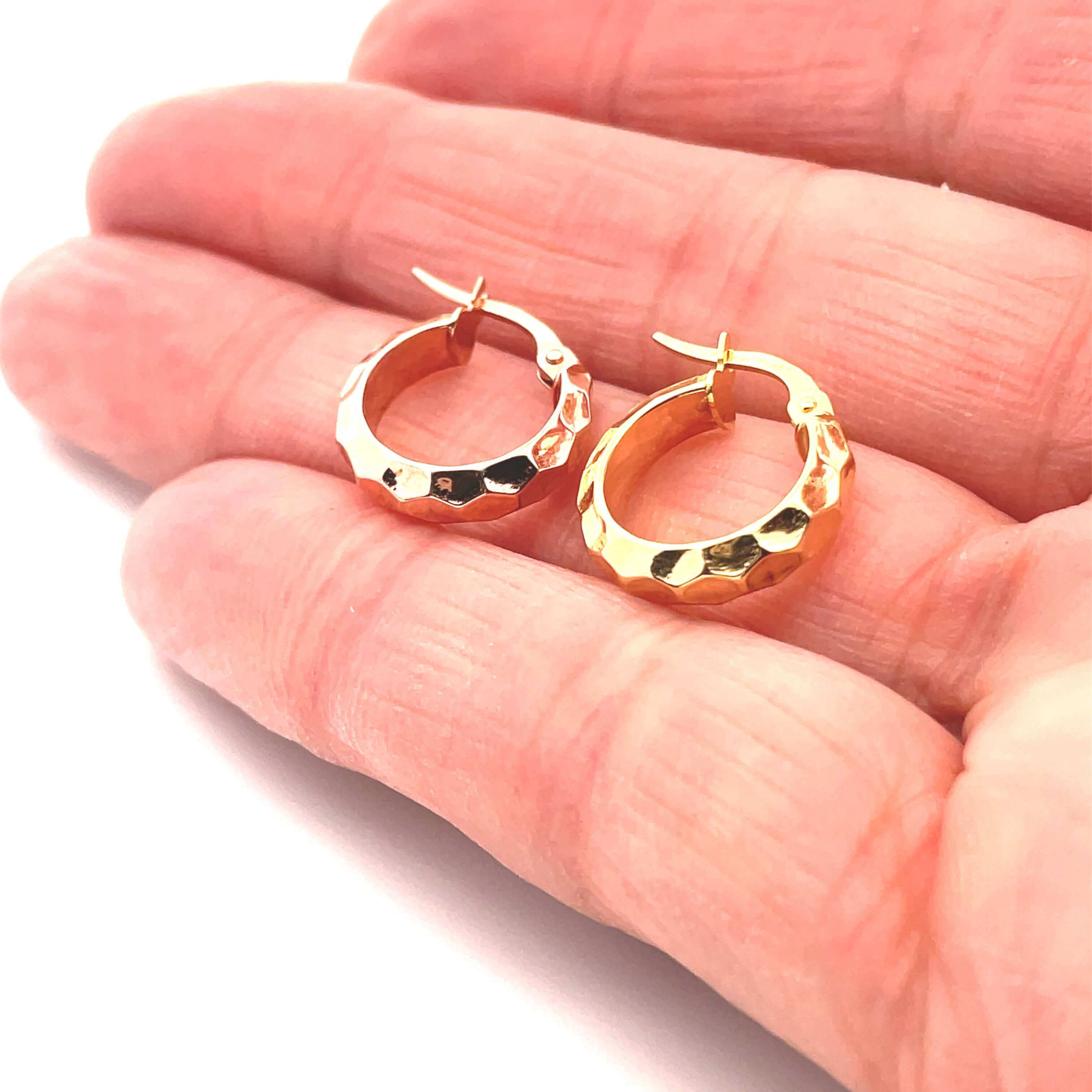 Gold Honeycomb hoop earrings on a hand