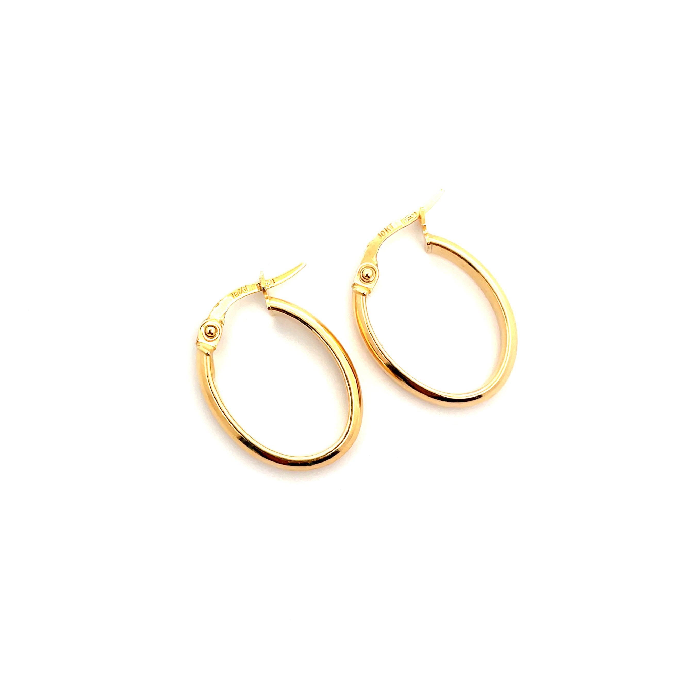 gold oval hoop earrings on white background