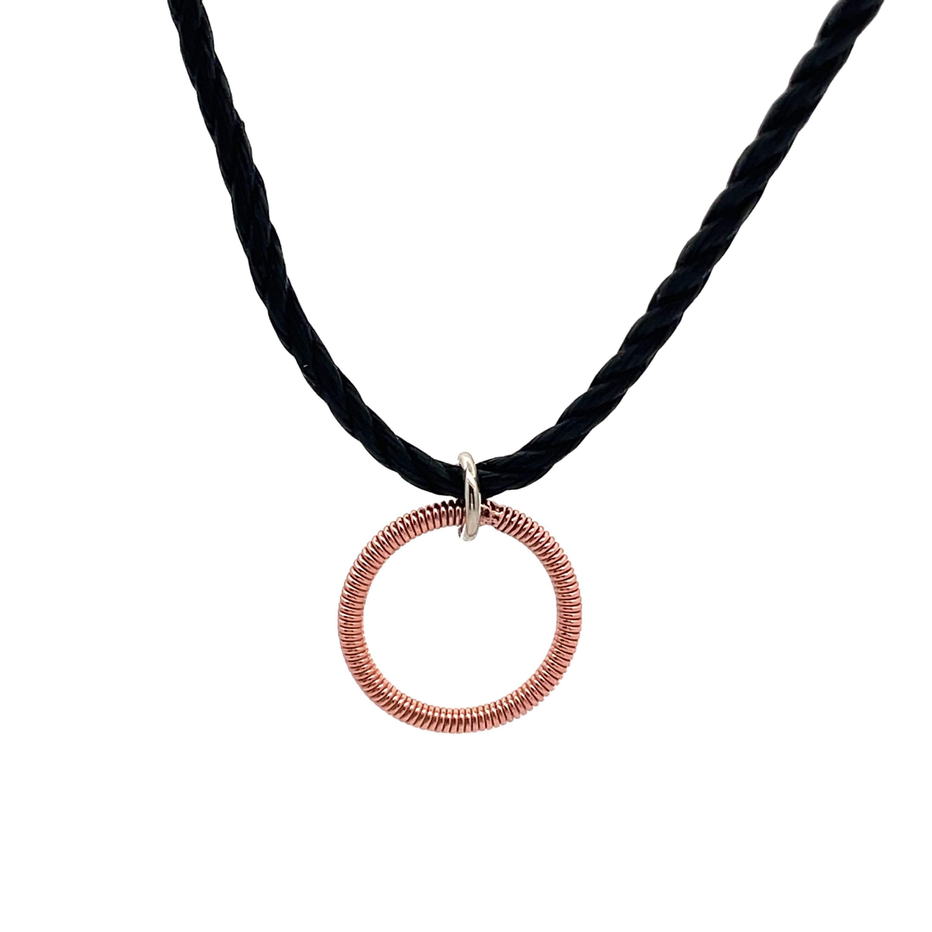 piano string circle pendant on black cord on white background